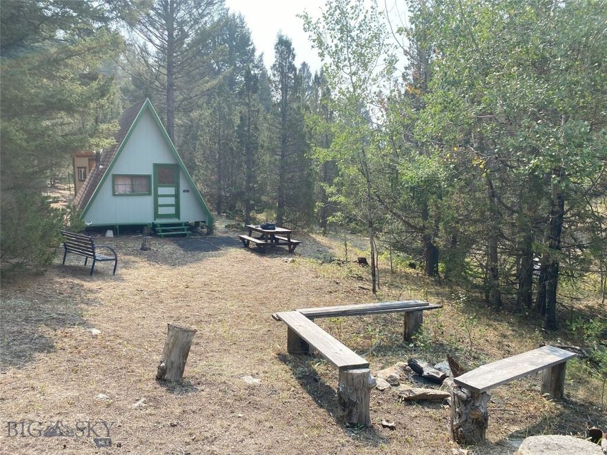 A Hunter's Paradise with Unrivaled Access!
Discover the ultimate recreational and hunting property, a 1-acre wilderness retreat that borders thousands of acres of USFS land, offering unparalleled access to prime hunting grounds. This secluded haven is a dream come true for those seeking to unplug and embrace the great outdoors.

The property features two charming dry cabins. The main A-frame cabin is a cozy retreat with a loft and a full-size mattress, a wood-burning stove to keep you warm on chilly nights, and a convenient dry kitchen area on the ground floor. A second dry cabin provides additional sleeping space, accommodating 2-3 people.

Step outside to find a dedicated campfire area, complete with a fire pit and picnic benches, perfect for relaxing after a day of hunting or hiking. With ample flat space, the property can easily accommodate larger groups with plenty of room for tent camping.

Located in a remote and secluded area, this property is a hunter's sanctuary, with deer and elk as the main game. While the access road is seasonal, the property can be accessed year-round if you are willing to enjoy a couple-mile hike in the snow. This is a rare opportunity to own a private basecamp with limitless access to a vast, pristine wilderness.