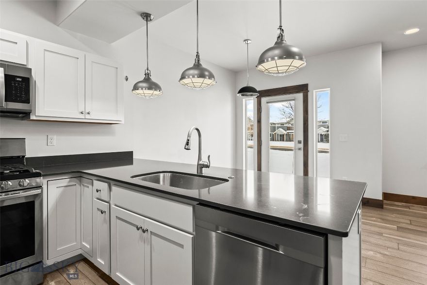 Welcome to this inviting 3-bedroom, 2.5-bathroom condo perfectly situated in the heart of Bozeman. The main level features laminate wood flooring throughout, a cozy gas fireplace, a functional kitchen with adjoining dining area, a convenient half bath, and direct access to the attached one-car garage. Upstairs, you’ll find a spacious primary bedroom with an ensuite bathroom, two additional bedrooms, a full bath, a dedicated laundry area, and a versatile loft/living space ideal for an office, media area, or playroom. This condo offers exceptional convenience with its central location—providing quick access to Montana State University, local shopping and amenities, and Yellowstone International Airport. Whether you’re seeking a full-time residence or an investment property, this home delivers comfort, practicality, and unbeatable convenience in one of Bozeman’s most desirable areas.