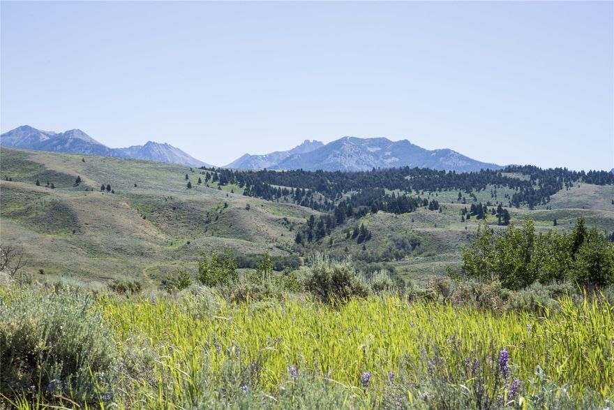 This 4.188 acre lot borders a beautiful pond on the ranch common area and has great Madison River views. This lot also has a large stand of Aspen trees just west of it, with a small spring fed stream adjoining it. This lush lot has fantastic views of the mountains and good access to the 3 miles of Madison River that runs through this upscale ranch community just south of Ennis, Montana. Living in Sun West Ranch gives you access to equestrian facilities, hiking on many trails on and off the ranch, and access to premier hunting. Live the Montana ranch lifestyle without the worry! Experienced ranch management will handle the details. Yellowstone National Park is only a half hour away.