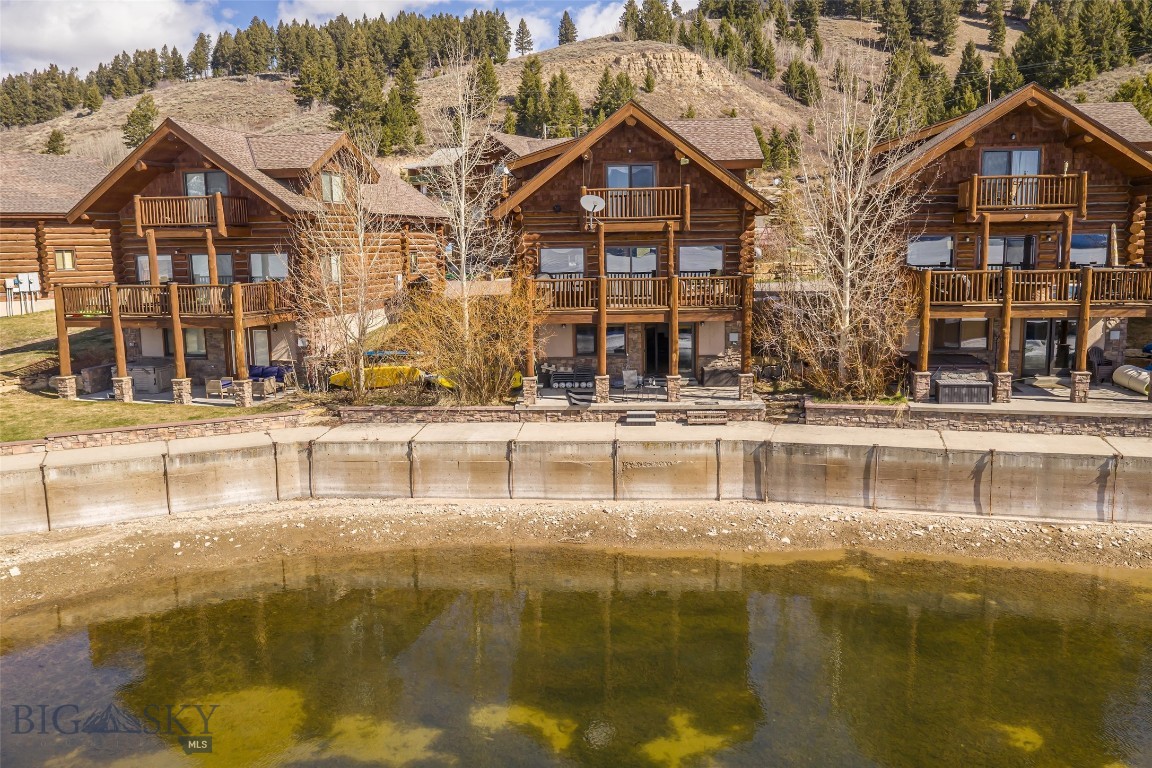 Escape to Montana’s untamed beauty in this rare waterfront retreat, perfectly positioned on the pristine shores of Hebgen Lake, and adjacent to the infamous Happy Hour Bar. Tucked into a rare setting with expansive lake frontage, this meticulously maintained cabin offers timeless mountain charm with elevated, modern comforts.
Surrounded by the panoramic lake and mountain views, the home invites you to slow down and reconnect—with nature, with loved ones, and with yourself.
Whether you’re fishing at dawn, boating in the summer sun, or snowmobiling in the winter, 70 Lake Shore Drive is your year-round sanctuary—just minutes from the west entrance to Yellowstone National Park and all the adventures of Big Sky Country.