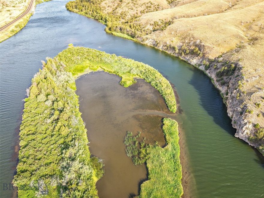 This unique property in Broadwater County, Montana offers a rare opportunity to own a heavily vegetated island tract with significant waterfowl habitat and direct Missouri River access. Located approximately three river miles upstream of the Toston Dam and a public boat launch, the parcel is well-positioned for seasonal recreational use. Its shallow water cove, mature foliage, and established cover make it an attractive option for waterfowl hunters and wildlife observers. Remnants of an old duck blind can be seen within the island's shallow water cove telling a long forgotten story of past waterfall hunts on this unique offering. The island provides natural shelter and food sources for ducks, geese, and other species that frequent the Upper Missouri River Basin. Public lands on the adjacent riverbanks also provide additional boat/raft launch points and areas for outdoor activity and seasonal access to fishing, hunting, and hiking.

The tract's heavy vegetation consists of native grasses, shrubs, and mature riparian trees that contribute to excellent concealment and habitat value. This same foliage creates a barrier of seclusion, ideal for recreation. Access is by boat or watercraft during appropriate seasons, as the parcel is surrounded by the flowing river channels. With private ownership of island properties becoming increasingly scarce in the Western U.S., this property stands out for its location and proximity to hubs like Bozeman and Helena. The land is undeveloped and lends itself well to low-impact recreational uses. This stretch of river is known for trout and walleye angling opportunities. Please note that the land has frequent flood potential and actual acreage is dependent on erosion and water levels. While the legal description says 12 acres, the land above the high water line is substantially less. Please see links on the listing for Montana water law as it relates to navigable waters in the state.
- Private Island on Missouri River
- ~3 River Miles Upstream of Toston Dam
- Secluded water inlet for privacy and waterfowl hunting
- Lush grasses and riparian trees/foliage
- Flood plain, likely not suitable for permanent structure
- Trout and Walleye Opportunities