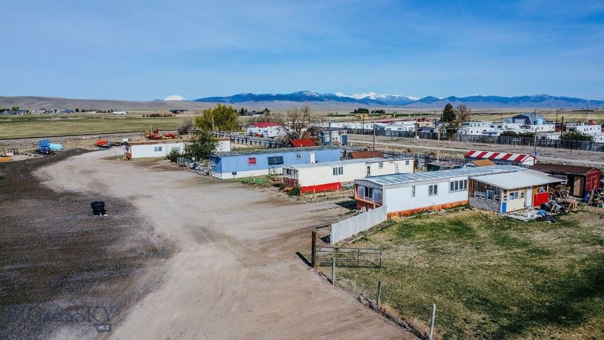 Discover an established investment opportunity set on two 2+/- acres minutes from town in Southwest Montana. The property includes one fully owned manufactured home and three currently rented manufactured home lots, two wells and septic units with room for additional building. Partial fencing and plenty of parking creates nice privacy and convenience for tenants. A blank slate that is awaiting your execution of wonderful ideas.  This provides both flexibility and the chance to grow your portfolio in a gorgeous setting.