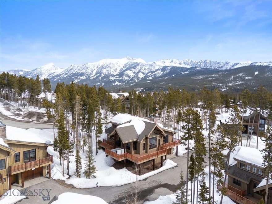 Tucked on a corner lot in Cowboy Heaven, this thoughtfully crafted mountain home offers a rare dual-direction ski experience—with the ability to ski home and convenient ski access out to both the Madison Base Area and Moonlight Lodge, just steps away. This coveted location combines proximity to Big Sky Resort terrain with the quiet privacy of a peaceful neighborhood setting.
The open-concept layout connects the kitchen, dining, and living areas, creating a warm and welcoming space ideal for cozy après-ski gatherings. Multiple fireplaces add charm and comfort throughout, while large windows capture views of Lone Peak and the surrounding landscape.
A spacious wraparound deck with hot tub offers the perfect spot to enjoy morning coffee, watch wildlife, or relax after a day on the mountain. Optional Moonlight Basin membership includes access to the private lodge, fitness center, lake activities, dining, and trail systems.
Sold furnished and move-in ready, this home is your four-season base in one of Big Sky’s most desirable resort communities, Moonlight Basin.
