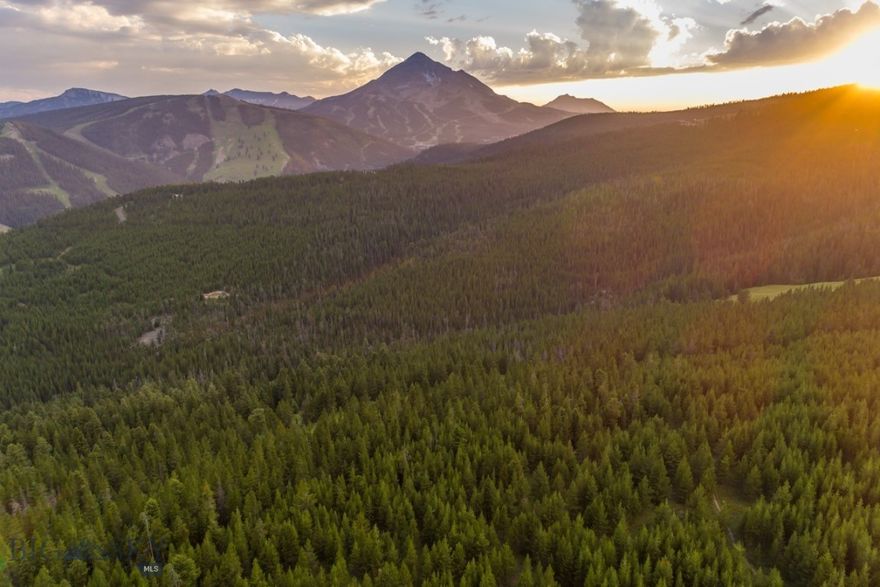 A rare and enduring legacy property in the heart of Big Sky, Montana, this remarkable 320-acre landholding is situated within the highly sought-after North Fork corridor—an enclave valued for its privacy, dramatic scenery, and close connection to all that Big Sky offers. Sweeping, unobstructed panoramic views extend across the Spanish Peaks, Gallatin Range, Lone Mountain, and Pioneer Mountain, creating a setting that feels both expansive and profoundly timeless.

Bordered by thousands of acres of protected National Forest, the property enjoys exceptional privacy and direct access to an extensive network of private and backcountry trails, ideal for hiking, mountain biking, Nordic skiing, and year-round outdoor recreation. The landscape unfolds as a rich mosaic of alpine meadows, old-growth forests, and gently rolling terrain—an extraordinary canvas for a private mountain retreat, conservation-focused vision, or thoughtfully planned luxury development.

Despite its remarkable sense of seclusion, the property lies just minutes from Big Sky Town Center, Montage Big Sky, One&Only Moonlight Basin, and the world-class skiing of Big Sky Resort, offering seamless access to dining, shopping, skiing, and year-round mountain amenities. Opportunities of this scale and setting, so closely connected to the heart of Big Sky, are increasingly rare.

A truly exceptional offering, this 320-acre legacy property represents one of the last great private landholdings in Big Sky, Montana—an irreplaceable opportunity to steward a remarkable landscape while creating a legacy of lasting significance for generations to come.