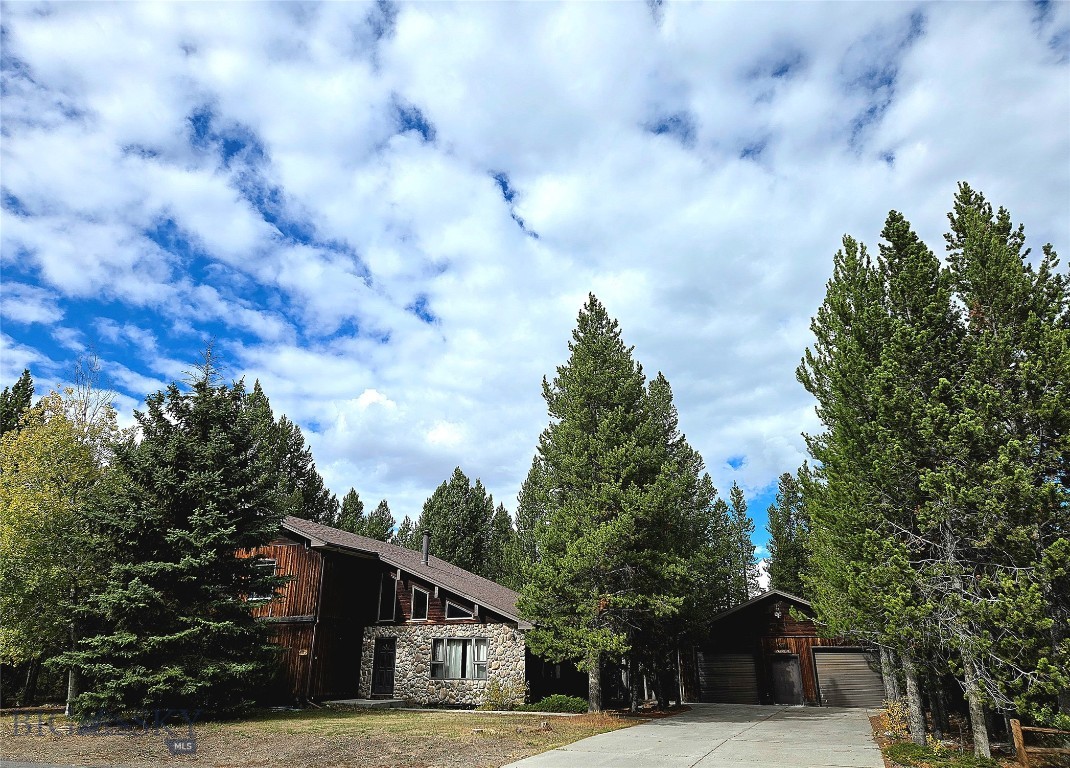Nestled among pine trees and just minutes from Yellowstone National Park’s entrance, this welcoming 2,852 sq. ft. home offers a unique combination of comfort, privacy, and a close connection to nature. Situated on two lots in the Madison Addition, the residence is surrounded by beautiful scenery and presents a wonderful opportunity for homeownership in this highly sought-after area.
This home features four bedrooms and three full bathrooms, providing ample space for families and guests. Vaulted ceilings in the main living room create an open and airy ambiance, accentuated by warm, natural light. The layout includes a large family room, a generous living room, kitchen and dining area.
Step out from the dining room onto a private patio deck surrounded by trees—perfect for relaxing outdoors or entertaining guests. From the deck, enjoy peaceful views and take in the tranquil beauty of Yellowstone living.
This property also offers a two-car garage and a wide driveway, ensuring plenty of parking and convenience. There is a full basement that provides the potential for additional living space.
Located in a quiet and desirable neighborhood only five minutes from Yellowstone’s West entrance, this home is the perfect choice for a permanent residence or a vacation retreat in Yellowstone.