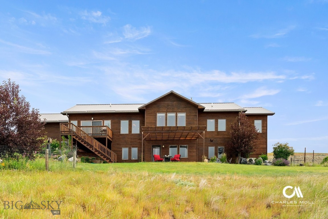 Live your #YellowstoneRanch dream in this beautiful Grassy Mountain Ranch home on 27+ acres that border a large private Montana ranch. Mike Day Creek flows through it, and the south-facing windows not only offer solar warming but provide the focal point of the near view, a small reservoir and the red rock bluffs that rise above it. This stunning location is encircled by the Bridgers, Mount Edith, the Crazy Mountains and the Castles. White Sulphur Springs is a short 20minute drive away, a thriving small town that features a hot springs spa, brewery, bakery, golf course, new library and more. The custom built 3000+ sf home is tastefully appointed with tigerwood floors(exotic hardwood), alder cabinets, and quartz countertops throughout. Floor to ceiling stone gas fireplace is the centerpiece of the main floor great room.
Enclosed sunroom is the perfect spot to train your spotting scope on the myriad of wildlife that frequents the rolling plains before you. Lower level features a living room, 2 bedroom suites, and walk-out to patio pergola, perfect for entertaining. FIBER OPTIC wifi, 80min to Bozeman, 65 min to Helena