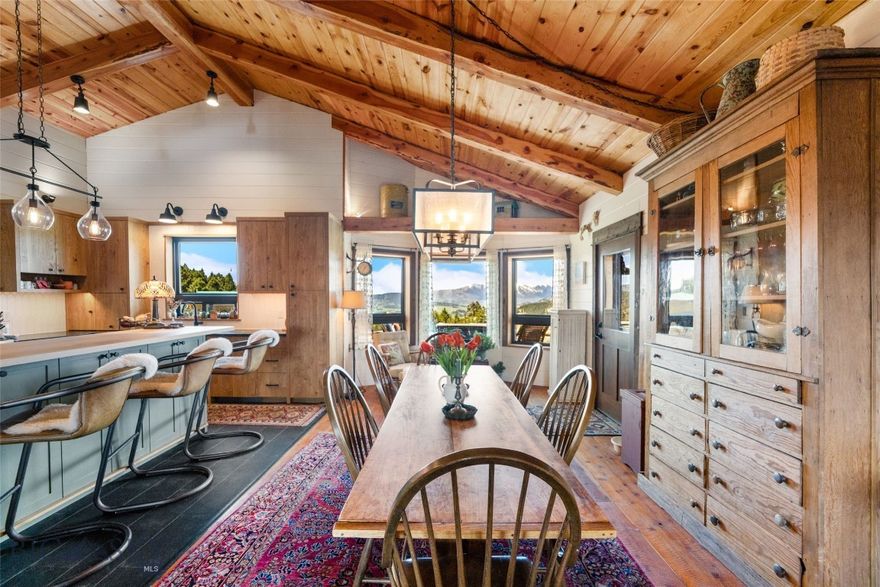 Nestled on 20 private, sloping acres up Quinn Creek, this extraordinary property offers breathtaking 360-degree views of the Bridger Mountains and Absaroka-Beartooth Range—truly some of the most spectacular vistas in Montana.
Wake up to sunrises over the Absarokas, and wind down as the sun sets behind the Bridgers, all from the comfort of your deck-side hot tub. This 2,801 sq ft, 3-bedroom, 2-bath home blends modern comfort with classic Montana charm. Exposed wood beams and log accents throughout the interior create a warm, rustic elegance that pairs beautifully with contemporary upgrades.
The newly renovated kitchen is a showstopper: soapstone countertops, custom cabinetry, high-end appliances, and in-floor heated tile offer both function and style. The living room centers around a Tulikivi soapstone wood stove, providing radiant heat and a striking architectural focal point, while new windows frame ever-changing mountain vistas and fill the space with natural light. Hardwood floors run throughout, adding timeless appeal.
The primary suite is a private retreat with a luxurious en suite bathroom, including a deep soaking tub perfectly positioned to soak in the stunning mountain views.
A spacious attached two-car garage offers convenience, while a detached two-car shop is currently outfitted as a home gym, storage and sauna—ideal for recreation and wellness. 
For guests or added flexibility, a charming barn features a one-bedroom apartment above, perfect for visitors, a caretaker, or rental income.  The barn itself has loads of storage and is set up for horses with 3 stalls and room for a tractor (or two). 
Whether you're seeking solitude, a family compound, or a unique Montana lifestyle property, this rare offering delivers privacy, comfort, and views that must be seen to be believed—all just a short drive from both Bozeman and Livingston.