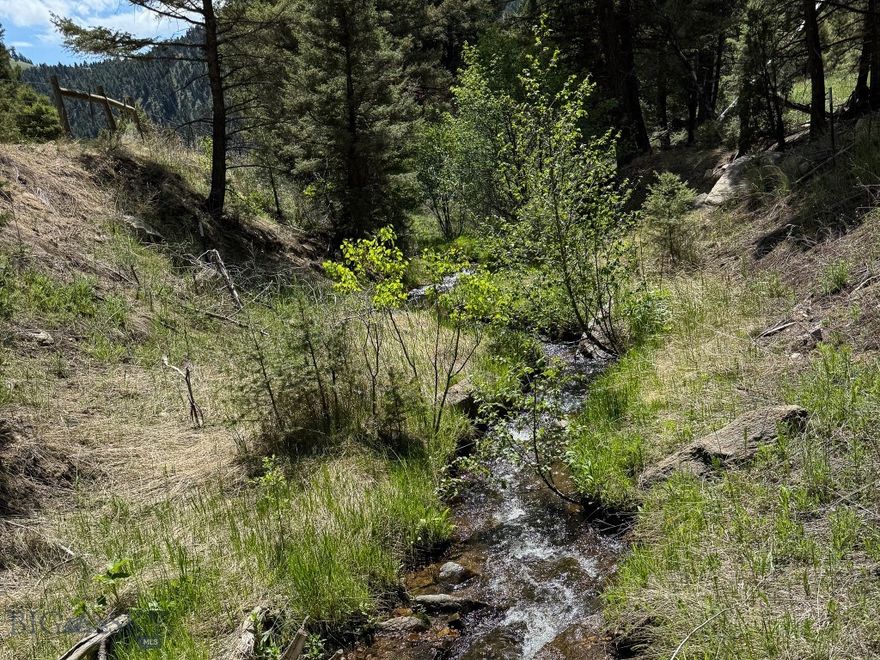 Don’t miss this amazing opportunity to own a beautiful mountain lot with year-round creek frontage, and power at county road. The property offers incredible hunting opportunities, with deer, elk, and bears frequently seen in the area and on the nearby public land. Outdoor enthusiasts will love the abundance of recreational activities in the area. You’ll be close to expansive BLM and Forest Service lands for hunting, surrounded by many creeks and rivers ideal for fishing. This parcel lends itself to an easy commute to Helena, Boulder, or Butte as it is about 1 mile from I-15's High Ore Exit. The seller will grant an easement with sale to get onto property from adjacent parcel/county road. The seller also has a bridge structure that they will negotiate on if buyer decides to cross the creek to their build site. A BLM "right of way" could be another viable option for a buyer to avoid crossing the creek.

This property is a patented mining claim, and seller's mineral rights convey with the sale. Affordable creek properties are not easy to come by, so don't miss your opportunity.