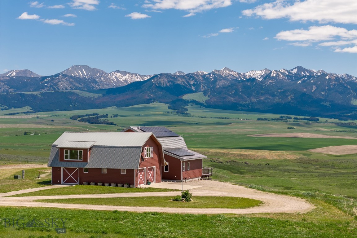 The exceptional Quill Hill Ranch is the embodiment of Montana dreams—wide open spaces, breathtaking panoramic mountain views, and a thoughtfully designed custom home that perfectly balances luxury and rustic charm. Set on 130 private acres, the land is fully set up for horses and outdoor living, offering the ultimate retreat just 15 minutes from the National Forest, with the Shields River nearby. Just minutes from the charming town of Wilsall, where you’ll find local dining, a grocery store, a cozy coffee shop, a medical clinic, a post office, and a gas station. For even more conveniences, the vibrant communities of Livingston and Bozeman are within easy reach, offering a wide range of shopping, dining, and amenities. Bozeman Yellowstone International Airport is the largest airport in Montana, offering direct flights throughout the US. Enjoy Southwest Montana’s endless recreation in the nearby Crazy Mountains, Bridger Mountains, Yellowstone National Park, and Bridger Bowl. The custom-built residence is bathed in natural light thanks to massive windows that frame awe-inspiring views and bring the outdoors in. Inside, the spacious floor plan features a gourmet kitchen with high-end finishes, a striking rock wood-burning fireplace in the great room, and two luxurious primary suites offering comfort and privacy. You will find two more bedrooms and a family room in the walk-out lower level. The beautifully finished ADU above the detached heated 3-car garage includes a full kitchen, bathroom, and flexible living space, ideal for guests, extended family, multigenerational needs, or a creative studio. The property is designed for self-sufficiency and year-round functionality, with a chicken coop, greenhouse, raised garden beds, solar power, a heated garage, perimeter fencing, and year-round geothermal well waterers for animals. Paved roads are maintained by the county through the winter. Acreage has agricultural status, and the pasture is leased to the neighboring rancher. Whether you're watching wildlife roam the property, riding through open pastures, or simply enjoying the peace and privacy of your surroundings, this is true Montana living at its finest. No HOA dues and no covenants. High-speed internet is available at the property. Current owners work from home with great connectivity.