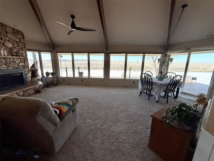 Riverfront Living on the Yellowstone River – Glendive, Montana
3 bed | 2.5 bath | 2-car heated garage 
This architecturally distinctive home offers a thoughtfully designed main level with a functional layout.  The  kitchen features an R/O filter, rich wood cabinetry, generous counter space, smart appliances, gas range, and a breakfast nook overlooking the living room, river, and beyond. The upper living room is anchored by a striking stone gas fireplace and wall of windows with panoramic views.  Access to a low-maintenance deck overlooking the majestic Yellowstone River, complete with hot tub and outdoor gas hookup — truly a front-row seat to the Yellowstone River. 2 bedrooms, 2 baths, and laundry are conveniently located on the main level. Primary bedroom with views of the river and a spa-style soaker tub, in-floor heat, granite double vanity, smart bidet heated toilet with automatic open/close, and tiled walk-in shower. The fully finished lower level includes an additional bedroom, kitchenette, separate entrance, and spacious living area with a gas fireplace — ideal for guests or multi-generational living, long-term guests, extended stays, or potential income-producing opportunities. Additional features include Andersen double-pane windows, on-demand water heater, whole-home water filtration, soft water, central air, and professionally serviced mechanicals, and exterior security blinds. Located near shopping, schools, and hospital — whether you're relocating, investing, or accommodating extended family, this is The Montana lifestyle opportunity you’ve been waiting for!