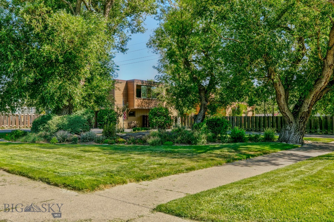 Just blocks from downtown Livingston's charming shops and restaurants and set on an oversized lot (14,000sf), this roomy, light filled home offers such a good blend of privacy, space and convenience.
Coming into the house, the first thing one notices is the beautifully landscaped, big, fully fenced garden. Carefully tended over the years that this has been a much loved family home, there are gorgeous lawns and flowerbeds, raised beds full of fruit and rambling vines on the trellises. There is probably not another home in Livingston that has such a sense of retreat from the bustle of the town. Inside, there is an easy, open floor plan that works so well either for indoor/outdoor summer entertaining or holiday gatherings in the winter. There are three bedrooms and one full bath on the main level and a non conforming bedroom with it's own three quarter bath in the basement. Upstairs, the large, comfortable family room is the heart of the house where everyone gathers: filled with light from all the big windows, there's space enough for movie nights, game tables - even a random treadmill or Peleton! Sitting in the sun room which overlooks the garden is like being in a tree house with all the dappled light coming through the spreading branches and leaves of the tall trees.
There are options here: reimagine the clean lines of this well cared for 1970's home or - start over: build your dream home and have an investment property next door (remember, there are 4 city lots here). In either case, you will own a property in one of south west Montana's most sought after communities: Livingston, a city rich in history and culture with a vibrant downtown area and abundant recreational opportunities up and down the Yellowstone River, still is a small town with a community of people who care deeply about where they live. So call your realtor, take a look in person or we'll be glad to send you a video tour. Could this be home?