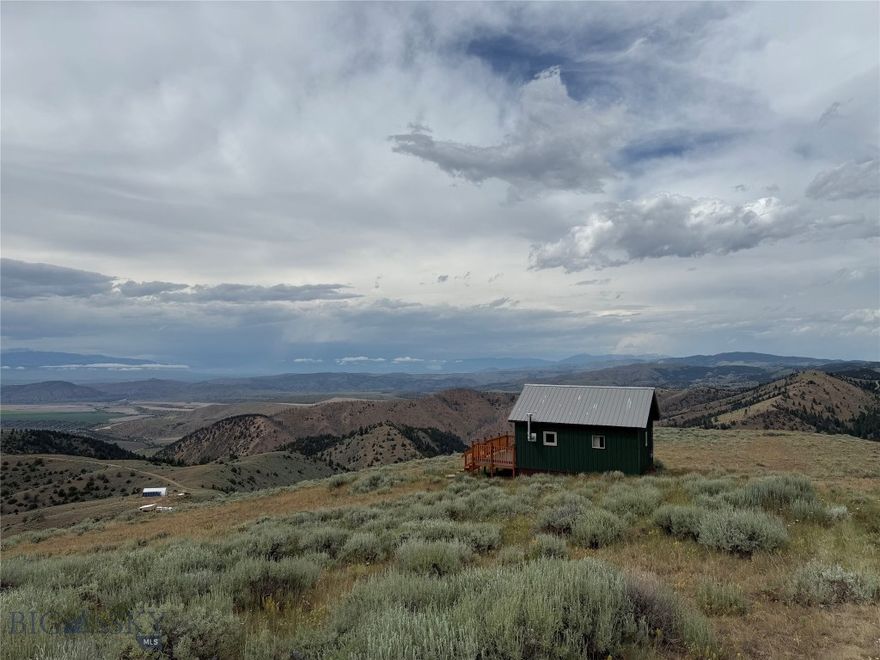 Top-of-the-World Tranquility – 357 Pole Gulch Road, Three Forks, MT
Offered at [$265,000] | 10.012 Acres | Built 2023 | Studio Cabin Retreat

Escape the hustle and recharge your soul at this one-of-a-kind mountaintop retreat tucked away in the heart of Ponderosa Pines. Perched at the top of the mountain, 357 Pole Gulch Road offers sweeping, panoramic views that stretch for miles — the kind of peace and quiet that’s hard to find and impossible to forget.

Built in 2023 and never occupied, this brand-new off-grid studio cabin is a minimalist’s dream and a nature lover’s haven. The open-concept interior features a full kitchen, full bath with a compost toilet, and cozy living space, all warmed by a wood-burning stove. Appliances run on propane, and a 500-gallon water tank is already in place for your convenience. While there’s no well or septic, this cabin is perfectly set up for simplified, sustainable living.

Enjoy your morning coffee or evening sunsets from the spacious front porch, where the only sounds you’ll hear are wind in the pines and the occasional songbird. With 10.012 acres of untouched Montana land, you’ll feel worlds away — yet you’re just a 30 min drive from the charming town of Three Forks.

No close neighbors and no distractions. Just peaceful, secluded mountain living — ideal for a weekend escape, creative retreat, or off-grid basecamp.