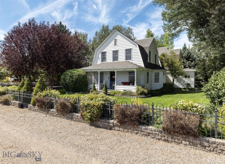 Nestled in the quiet little hamlet of Jeffers, MT, w/ stunning views of the majestic Madison Range, this stately historic landmark residence is one of the original Jeffers family homes, located only 1.5 mi from Ennis, MT. Built in 1900 & restored to capture the look of Montana’s Gilded Age. The main home offers 2 primary suites & has a total of 5 BR & 5 BA. The main house can comfortably sleep 10 people. The 1st floor includes a large owners suite, beautifully furnished with antiques from around the world, a full ensuite bathroom including a jetted tub, fully tiled shower & large walk-in closet. There is a formal dining room, living room, library, utility room & foyer entrance. Also featured on the 1st floor is a newly renovated stainless steel, quarts counter-top kitchen that is the final modern touch that makes this residence truly stand out. The 2nd floor of this home has the 2nd owner’s suite that includes its own private terrace, a large full bath, office space & TV sitting area. There are 3 additional bedrooms & a hallway bath that completes the 2nd floor. Additionally, there are linen & housekeeping closets. Finished in 2022 is The Bear's Den, a 750SF cottage hidden just across the bridge, landscaped backyard. This cute little cottage has a great room w/ 14-foot ceilings. There is a kitchen, king-size bedroom & a 3/4-bathroom w/ a walk-in closet. There is a private stone patio area with a water feature, seating & BBQ. This cottage & its patio are barely visible from the main house. Very private & quiet, perfect as a small rental or great as an owner's residence when the main house is being used as short or long-term rental. Attached to the cottage, is a covered RV parking area w/ a separate shop & storage enclosure. The property also offers a 90SF detached 2 car garage w/ automatic door openers. The garage has 2 fridges, 1 freezer & a dry or canned goods pantry. Also in the garage is a lockable, walk-in closet. The highlight of the garage is the comfortable studio & bedroom attached on the western side of the garage that measures 240SF. It’s the perfect private space to work with power & Wi-Fi. Because of its great Micro-Climate this property offers beautiful outdoor living spaces. A large Roman Stone Patio has a BBQ, casual seating & dining areas. There are perennial flower gardens, 3 water features, towering shade trees, lush lawns & mature landscaping.  Cedar Creek flows seasonally through the property lending its gently ambiance.