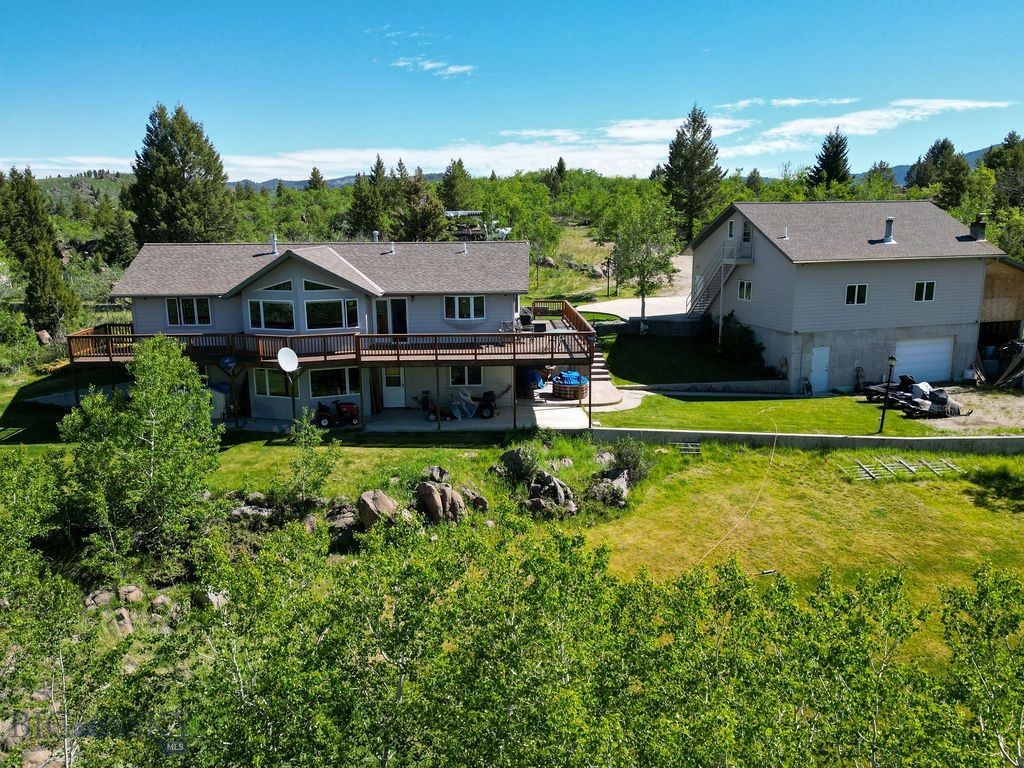 Welcome to your private Montana escape! Nestled on 16.93 acres of beautifully treed landscape, this 2,880 sq. ft. home blends space, comfort, and craftsmanship. With 4 bedrooms and 2.5 baths, the all-wood interior was custom-built by a master craftsman, creating warmth and elegance throughout.
The property is designed for both living and entertaining: enjoy stunning mountain views from the expansive deck, or gather in the basement, already plumbed for a wet bar.
A true standout feature is the 5-car garage and shop. Plumbed for in-floor heat and a bathroom, it includes a dedicated wood shop and upstairs guest quarters, also plumbed for water—ideal for visitors, extended family, or even an Airbnb. An attached storage unit provides extra room for tools and toys.
Modern comforts include an air exchange system, reverse osmosis, radon mitigation, and a full alarm system. And now with a newly paved road, access to this serene property is easier than ever.
Love playing outside? Moulton Reservoir Nordic Ski trails are just down the road; perfect for winter-time fun, or hiking in the warmer months!