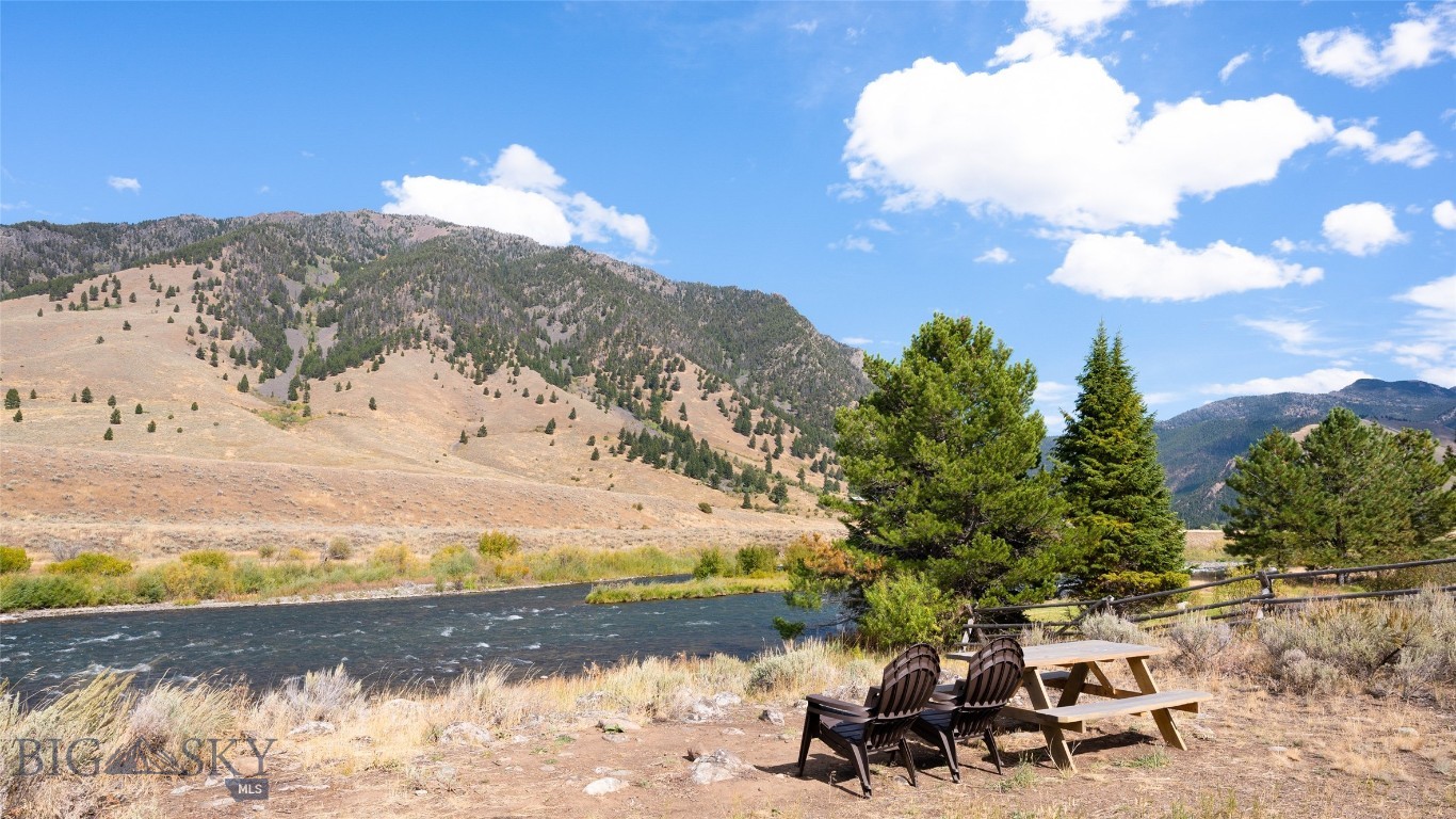 Rare Madison Riverfront Lot — Build-Ready and Waiting for You! Opportunities like this don’t come often — a build-ready lot on the legendary Madison River, offering privacy, quiet, and unmatched recreational access. Located in a small, private neighborhood with well-maintained roads and year-round access, this property is ready for your dream home or investment project. The well and septic are approved, with power and fiber optics already to the lot. Unlike many stretches of the Madison, this is a wade-only section — meaning no boats floating by, just the peaceful sounds of the river and the beauty of nature all around you. Short-term rentals are allowed, giving you flexibility whether you plan to enjoy the property yourself or generate income. Wildlife is abundant, and endless outdoor activities are nearby, from hiking trails and alpine lakes to world-class hunting and fishing.
There’s no active HOA with mandatory dues; property owners simply contribute as needed for road maintenance and snow plowing. This is one of the very few undeveloped lots remaining along this coveted section of the Madison River. Don’t miss your chance to own a piece of Montana paradise!