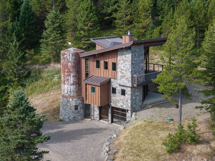Discover your private sanctuary amidst the majestic Montana landscape. This exquisite 2-bedroom, 2-bath mountain retreat, situated on 20 wooded acres, offers the ultimate in tranquility and natural beauty. Immerse yourself in the sounds of two year-round creeks flowing through your property, providing a truly serene setting. Inside the main home, you'll find a meticulously designed space featuring custom kitchen and bathroom lighting , a breathtaking spiral three-level staircase, elegant hardwood floors, solid wood doors and trim package, and premium hi-end finishes like soft-close wood cabinetry, quartz countertops, a wood burning fireplace and more! Just 18 miles from Bozeman's vibrant amenities and 25 miles from the international airport, this retreat provides the perfect balance of peaceful living and easy access. Guests will enjoy, a dedicated 1-bedroom, 1-bath guest quarters with views and a creek. There is an additional private RV hook up area with power and water that ensures comfort for all." The possibilities are many i.e., a year-round lifestyle, investment, corporate retreat or simply a wonderful Montana getaway!