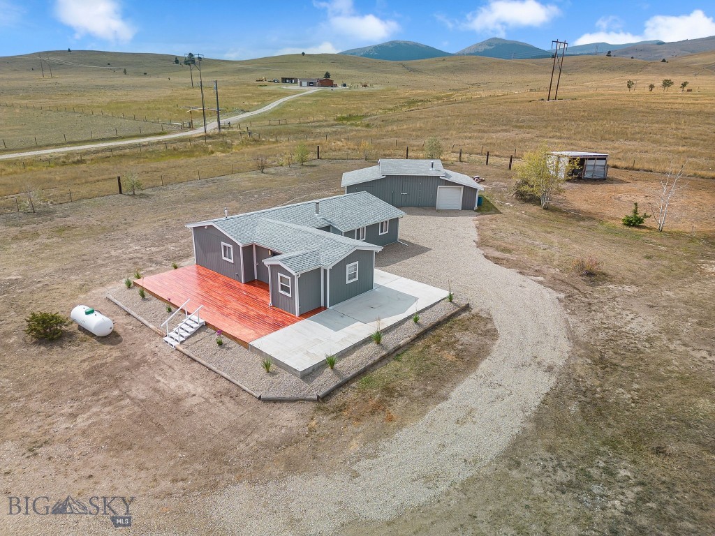 Seller financing offered! Enjoy wide-open Montana living on 20 fully usable acres with a beautifully renovated 2 bed, 2 bath home. Updates include a new roof, gutters, flooring, paint, wiring, wood stove piping, chimney, and a custom butcher block kitchen peninsula. A large new deck, patio, and landscaping make it perfect for outdoor living with stunning views of the Flint and Boulder Mountains. The property is fully fenced with five water spigots, ideal for horses or animals, and includes a shop for projects or storage. Wildlife like elk and deer frequently visit, adding to the charm. Located in a small, private subdivision just minutes from Anaconda, you’ll enjoy peace and quiet with endless recreation nearby—skiing at Discovery, fishing Georgetown Lake or the Clark Fork, golfing, hiking, hunting, or exploring thousands of acres of public land. This is true Montana living: room to roam, modern comfort, and adventure at your doorstep. Don’t let interest rates stop you—the seller is willing to finance!