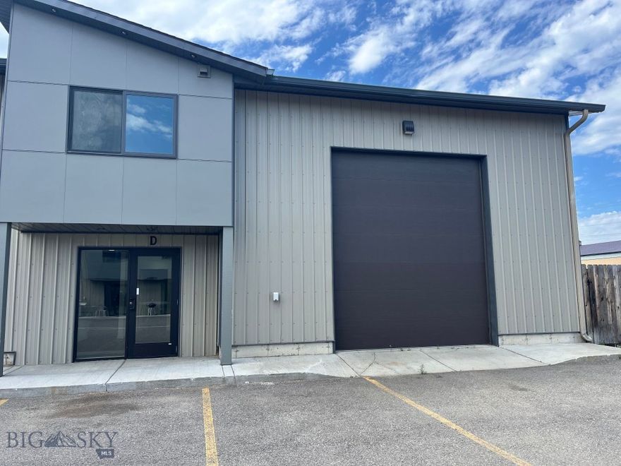 Prime warehouse space located just off Jackrabbit Lane in the heart of Four Corners—an ideal location for easy access to Bozeman, Big Sky, and Belgrade. This versatile unit features a 14-foot overhead door, 1-phase power, and a welcoming front entryway for customers. A carpeted mezzanine offers an excellent open office area, perfect for desks or collaborative workspace. The property also includes a fenced side yard with a separate man door and convenient parking directly in front of the unit. A great opportunity for a wide range of commercial uses in a high-demand area.