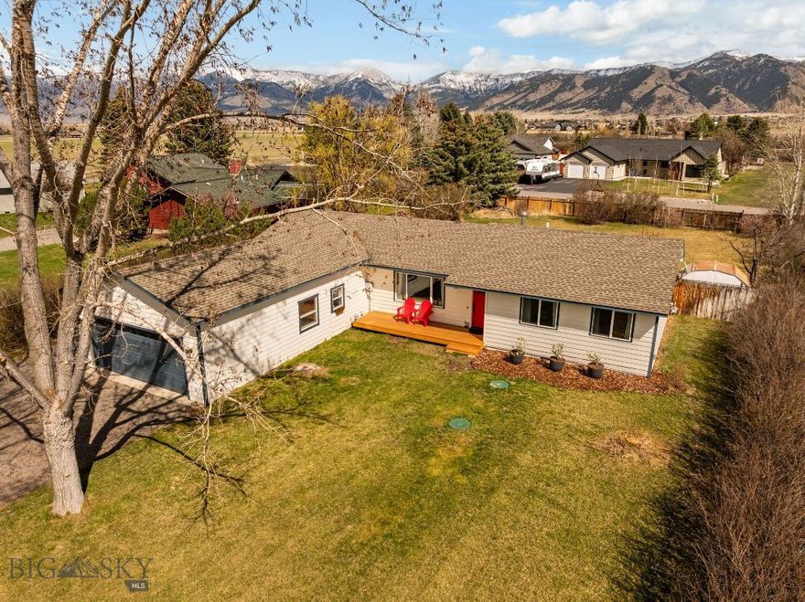 Beautiful Springhill area 3 bed 2 bath single level home on nearly 1/2 acre with large attached garage, workshop space, amazing Bridger Mountain views, updated kitchen, parking for toys and more! This modest neighborhood of half acre lots is tucked in with larger properties, farms, old homesteads, and multimillion dollar homes between north Bozeman and Belgrade. As you pull in to the property, take in the mountain views to the east and park under the canopy of mature trees that line the driveway. Take your time in the yard, walk onto your new front deck and look west to see the sunset and admire the privacy. Enter the home through the formal living room, a right turn will take you to the remodeled full bath, 2 guest rooms and the primary suite with attached remodeled 3/4 bath with tiled shower. Left at the entry will take you to the updated kitchen with pantry, stainless appliances, farm style sink and full tile backsplash. The large family room with gas fireplace and access to the back yard is just beyond the open kitchen/ dining area. Between the family room and garage are some features that make this home unique. Don't miss the giant storage/ gear closet across from the cozy private office space and the mud room with concrete floor and included washer and dryer. The attached garage is great for parking vehicles and toys along with an extra space that would be great for a gym, tools, tinkering or... The storage loft above the garage gives you easy access to seasonal items and things you don't need every day. The large back yard with included hot tub is partially fenced and ready for summer BBQ season. Additional parking and storage hidden to the north of the garage is great for trailers and back yard access. This wonderful home is located a few miles north of private Riverside Golf Club and public Bridger Creek Golf Course, easy access to the west side of the Bridger Mountains, and a short walk to the community park and playground.  Currently residents in this neighborhood enjoy a Belgrade address with students enrolled in the Bozeman school district. Check out this wonderful home today! (buyers and their agents to confirm all information to their satisfaction).
