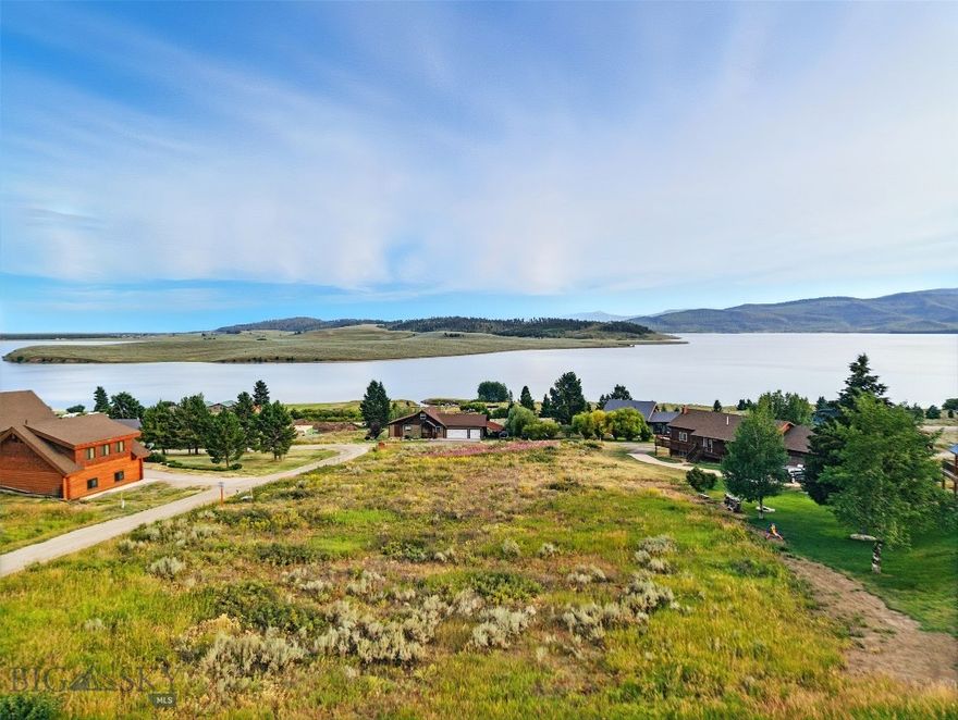 Welcome to your future home site in the coveted Yellowstone Holiday subdivision on the shores of Hebgen Lake, just minutes from the west entrance of Yellowstone National Park. This exceptional lot offers stunning lake views, a peaceful setting, and a strong sense of community with friendly neighbors nearby. Whether you're envisioning a cozy cabin retreat and winter snowmobiling or a custom year-round residence, this .4 acre property provides the perfect backdrop -where morning coffee comes with sunrise reflections off the water and evenings end with alpenglow over the mountains. With a full-service marina just across the street, you are just a stone's throw from fishing or boating. Big Sky Resort and world class skiing are only one hour away. The lot has electric to the lot and a community water system and is ready for your build.