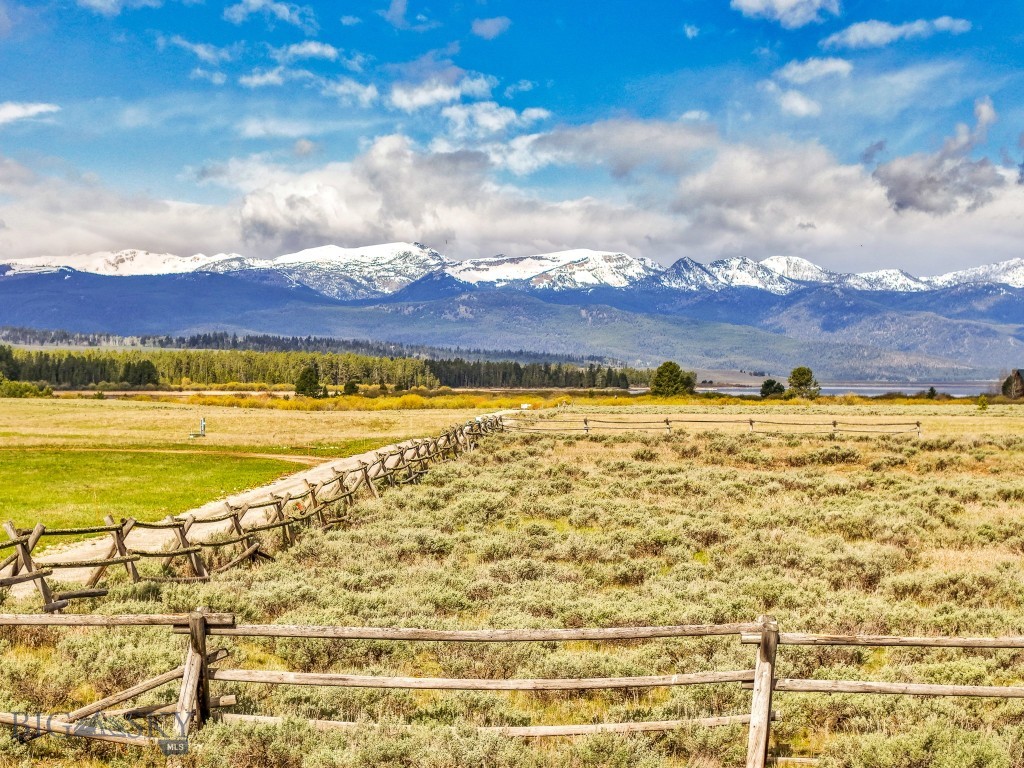 Build your dream retreat in Grayling Arm Meadows—where privacy, panoramic views, and thoughtful community standards create the perfect backdrop for your Montana life. This 5-acre lot offers commanding mountain and valley views, just a half-mile from Hebgen Lake and minutes from legendary trout streams. Covenants protect the peace: no short-term rentals, generous minimum home sizes not less than (2,500) square feet of living space for 2story homes and not less than (1,800) square feet of living space for a single level home, and guest houses allowed. Build garage space for RVs and multiple vehicles without cluttered streets. Enjoy seasonal June, July, and August horse privileges and a neighborhood where every property is built to match the surrounding natural beauty. Engineering site plan and septic in place—bring your builder and vision.