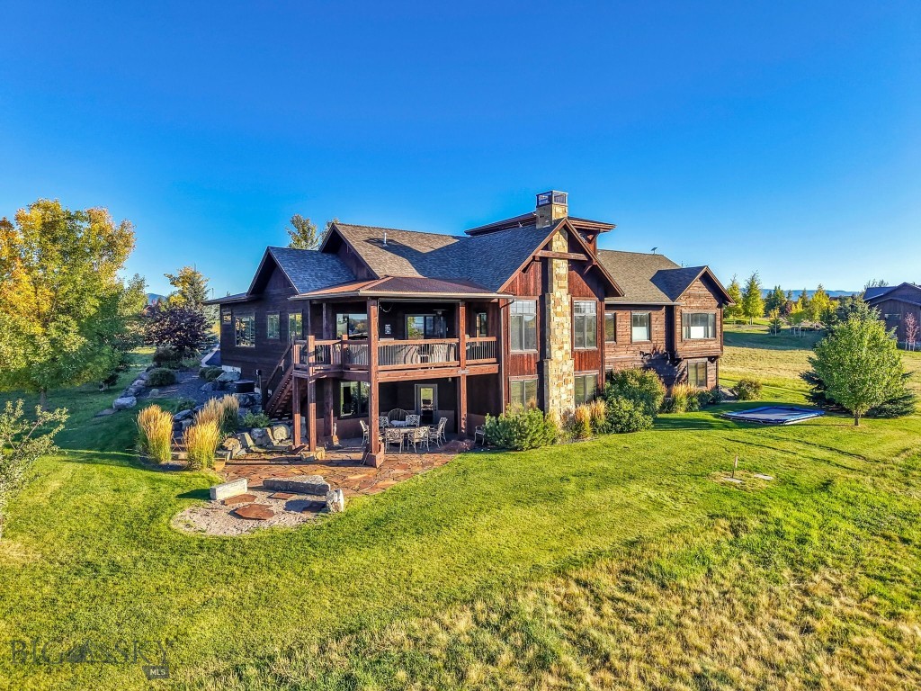 This exceptional home features 6 bedrooms, 4.5 bathrooms, and breathtaking views in every direction. Designed for comfort and style, it offers a home theater, wine cellar, and a spacious guest suite with its own private entrance. The gourmet kitchen includes an espresso machine and oversized pantry, perfect for entertaining. The primary suite boasts a steam shower and heated bathroom floors, while every bedroom includes a walk-in closet. Rustic wood accents, a Sonos sound system, and a second-floor belvedere room with sweeping 360° views add warmth and character. Outside, enjoy an expansive patio overlooking Hole 2, complete with garden beds, fruit trees, a fire pit, and an in-ground trampoline—truly the best of Montana living. The exclusive Black Bull community provides access to the golf course, pool, fitness center, private restaurant, walking and cross-country ski trails, and more.