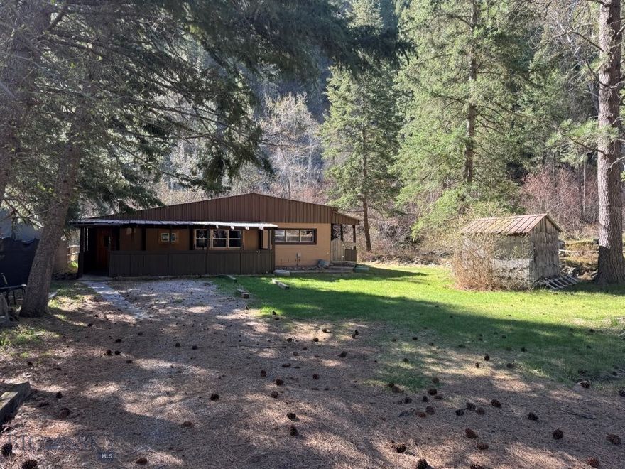 Invest in this cabin up Rock Creek! Nestled on 1.05 acres across the road from the world-class fishing of Rock Creek, this cabin is ready for your vision and work to completely renovate it. Once renovation is complete, this single-level 3 BR, 2 BA 1,838 sq ft cabin would make an excellent short-term rental combined with your personal escapes to enjoy the fishing, hunting, hiking and wildlife watching that the area presents. With its prime location near the Welcome Creek Wilderness and USFS land, this property has incredible short-term rental potential — anglers, hunters, and outdoor adventurers are always looking for the perfect Montana basecamp! Propane heat and a wood stove keep things comfortable year-round while the detached 2 car garage and 10x20 pole frame lean-to provide ample storage for all your toys and equipment. Bring your vision, update the interior to your taste, and start generating income or simply enjoy Montana living at its finest! Conveniently located 30 minutes southeast of Missoula.