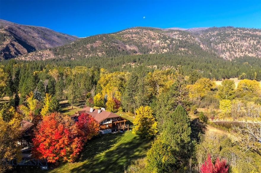 Welcome to Spring Mountain Sanctuary, ideally located in the northern reaches of Montana’s Bitterroot Valley. Minutes from the famed Bitterroot River and National Forest, this legacy property spans 84+ acres of classic pine trees, grassy forest meadows, a section of Tie Chute Creek, two ponds, and Horse Creek cascading next to a custom-built 5 bed/3 bath Montana log home. Natural light fills the home, creating an inviting space for entertaining and family gatherings. Valuable water rights support a lush landscape and a private, serene environment where outdoor Montana living thrives.

Just 20 miles to Missoula and minutes from the Bitterroot River and National Forest, the property offers convenient access to recreation while maintaining exceptional privacy.

Tie Chute Creek runs for nearly half a mile across the property, which also features two spring-fed ponds, two irrigation ditches, grassy pastures for horses or cattle, and a diverse mix of pine and deciduous trees, including Maples and Oaks that offer brilliant fall color. Horse Creek flows right near the home, enhancing the natural setting. The landscape blends mature timber and open meadows, creating both seclusion and expansive Bitterroot Mountain views. Large-acre neighboring parcels add to the peaceful rural setting.

At the heart of the property is a two-story, 6,800 sq ft custom-built, hand-peeled log home with 5 bedrooms and 3 bathrooms. Natural light flows throughout, creating a warm space for entertaining and gatherings. Also included are two offices, a craft room, living room stone fireplaces, cathedral ceilings, and multiple decks. Water rights support sustainable land use.

The property includes several outbuildings: a 1,700 sq ft 3-car garage and woodworking shop with a two-bedroom, one-bath apartment above; a well house for lawn equipment, boats, and gear; and a separate tractor/equipment shed. The land is perimeter and cross-fenced with jack-leg and barbed wire fencing, ideal for horses or a small cattle operation. County-maintained paved roads lead to the gravel driveway, ensuring reliable year-round access. The property spans four 20+ acre legal parcels.

Spring Mountain Sanctuary offers a rare combination of privacy, natural beauty, and usable infrastructure in a prime Bitterroot Valley location.
