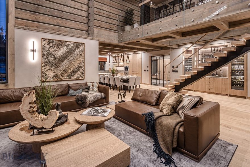 European company LHM Homes presents their first Norwegian style mountain home built in the U.S. Set in a quiet location within Spanish Peaks Mountain Club, this newly completed residence blends Scandinavian craftsmanship with fully turnkey refined mountain living on a private 2.5 acre lot. Furnishings, finishes, and accessories are meticulously curated, with many elements crafted exclusively for this home. Natural materials and modern elegance create a sanctuary of design, comfort, and quality. 
With 4 bedrooms, a large bunk room, 5.5 baths, a spa with sauna & hot tub, and a two-car garage, the floorplan balances gathering spaces with restful private retreats. The gourmet kitchen features include Gaggenau appliances, custom European oak cabinetry with Blum inserts, LED lighting, pop-up island outlets, and wireless charging integrated into the dining table. Leather cabinet hardware and magnetic locking interior doors elevate both beauty and performance.
Outdoor living is seamless with a stone terrace off the dining area and a wrap-around thermally modified ash deck that adjoins the primary suite to the private hot tub. It is the ideal place to relax after time spent skiing, golfing, hiking, or biking.
Interior details reflect an elevated standard throughout. Wide plank European oak floors with radiant heat ensure year-round comfort. The dramatic fireplace features a one-piece stone hearth sourced in Idaho. Triple-glazed European windows provide exceptional insulation and tranquility. Custom cabinetry and furniture designed and built in Europe fit each space with precision. Other features include a built-in sound system, integrated technology and lighting with a Lutron Caseta programmable system, multiple WiFi access points, and electric car charging. The residence includes a cold roof and ventilated wall structure to optimize energy efficiency and comfort in every season.
Multiple living areas and a custom wine/beverage bar with Gaggenau wine refrigerators and beer tap system  add convenience and sophistication. Every element from interior layout to furnishings and artwork was selected to reflect the natural beauty of its setting.
Spanish Peaks Club membership provides access to private golf, dining, ski in and ski out clubhouses, privileges at Montage Big Sky, and a welcoming community that celebrates outdoor adventure and relaxation. This residence is a lifestyle rooted in craftsmanship, tranquility, and a deep connection to Montana wilderness.