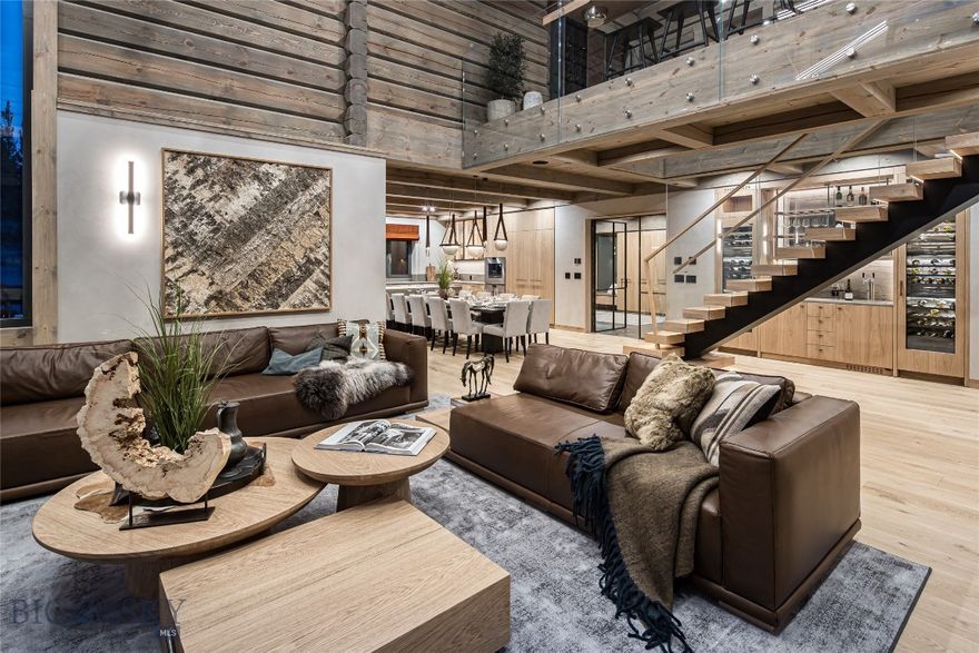 European company LHM Homes presents their first Norwegian style mountain home built in the U.S. Set in a quiet location within Spanish Peaks Mountain Club, this newly completed residence blends Scandinavian craftsmanship with fully turnkey refined mountain living on a private 2.5 acre lot. Furnishings, finishes, and accessories are meticulously curated, with many elements crafted exclusively for this home. Natural materials and modern elegance create a sanctuary of design, comfort, and quality. 
With 4 bedrooms, a large bunk room, 5.5 baths, a spa with sauna & hot tub, and a two-car garage, the floorplan balances gathering spaces with restful private retreats. The gourmet kitchen features include Gaggenau appliances, custom European oak cabinetry with soft close drawers, LED lighting, pop-up island outlets, and wireless charging integrated into the dining table. Leather cabinet hardware and magnetic locking interior doors elevate both beauty and performance.
Outdoor living is seamless with a stone terrace off the dining area and a wrap-around thermally modified ash deck that adjoins the primary suite to the private hot tub. It is the ideal place to relax after time spent skiing, golfing, hiking, or biking.
Interior details reflect an elevated standard throughout. Wide plank European oak floors with radiant heat ensure year-round comfort. The dramatic fireplace features a one-piece stone hearth sourced in Idaho. Triple-glazed European windows provide exceptional insulation and tranquility. Custom cabinetry and furniture designed and built in Europe fit each space with precision. Other smart features include a built-in sound system, integrated technology and lighting with a Lutron Caseta programmable system, and strategically placed WiFi access points. The residence includes a cold roof and ventilated wall structure to optimize energy efficiency and comfort in every season.
Multiple living areas and a custom wine/beverage bar with Gaggenau wine refrigerators and beer tap system  add convenience and sophistication. Every element from interior layout to furnishings and artwork was selected to reflect the natural beauty of its setting.
Spanish Peaks Club membership provides access to private golf, dining, ski in and ski out clubhouses, privileges at Montage Big Sky, and a welcoming community that celebrates outdoor adventure and relaxation. This residence is a lifestyle rooted in craftsmanship, tranquility, and a deep connection to Montana wilderness.