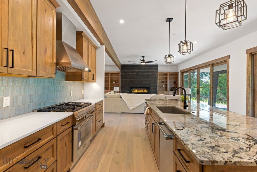 Newly constructed two-story custom home located in the prestigious Black Bull community, backing up to the serene golf course. This property is a true masterpiece, blending modern luxury with thoughtful design. You are immediately captivated by the exquisite details, including beautiful hardwood floors, custom beams, built-in shelving, and a sleek custom fireplace. These elements come together to create a warm and inviting living area that effortlessly flows into the heart of the home, an impeccable kitchen that’s a chef’s and entertainer's dream. Equipped with top-of-the-line stainless steel Thermador appliances, expansive cabinetry, and a spacious pantry, this kitchen offers both style and practicality. The island serves as a statement piece, showcasing a stunning granite countertop, bar seating, and additional cabinets for extra storage. Natural light floods the home through Anderson 400 series windows, enhancing the open, airy feel of each room and offering breathtaking views of the surrounding landscape from one of the most coveted lots in the private community. On the main floor, the luxurious master suite provides private patio access and a designated hot tub location. The spa-like master bath features heated floors, a stunning tile shower, a soaking tub, and dual vanities for added convenience. The large walk-in closet includes built-in shelving, providing generous space for all your wardrobe needs. Also on the main level, you’ll find a guest bedroom, a stylish half bath, and a laundry room complete with a utility sink, and an incredible entry closet with additional drop zone opportunities for every weather condition Montana throws at you. Upstairs, provides flexible space for entertainment. The master bedrooms, with their own luxurious full bathrooms, offer the same high-end finishes as the rest of the home, including custom cabinetry and beautiful countertops. Step outside to the deck off the second-floor living area, where you’ll enjoy panoramic views of meadows, farmland, golf course, and a peaceful stream—an ideal setting for relaxation or outdoor gatherings. This home also offers separate heating and cooling zones for each level, with ceiling fans in every room for added comfort. The attached 3-car garage is heated, includes a convenient drain, and offers ample space for storage and organization. (PHOTOS VIRTUALLY STAGED) (UPGRADES: METAL ROOF, WOOD CLAD WINDOWS, WOOD TRIM/DOORS, OUTDOOR FIREPLACE, INCREDIBLE CASHMAN LANDSCAPING PACKAGE)