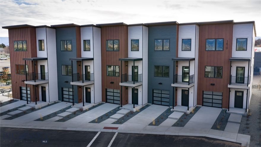 Located moments from downtown Bozeman, The Lofts on Beall is an exclusive collection of 11 beautifully crafted residences that blend modern luxury with a warm, elevated mountain aesthetic. This three-bedroom, three-bathroom condo offers a sophisticated retreat with high ceilings, oversized windows, and an open-concept layout that fills the home with natural light. The gourmet kitchen features custom two-tone cabinetry, sleek quartz countertops, and premium Café appliances—perfect for everyday living and effortless entertaining. A private balcony extends the living space outdoors with beautiful Bridger Mountain views, while each bedroom provides a peaceful sanctuary with refined finishes and calming design elements. Spa-inspired bathrooms and thoughtful details throughout highlight the project’s emphasis on comfort, quality, and craftsmanship. This home also features all-electric living, a forward-thinking and energy-efficient approach that delivers higher performance and lower utility costs through advanced heat pumps and electric appliances, cleaner indoor air with zero combustion inside the home, reduced environmental impact by eliminating fossil-fuel use, and enhanced simplicity and safety with no gas lines—an ideal fit for Bozeman’s newest modern luxury community.