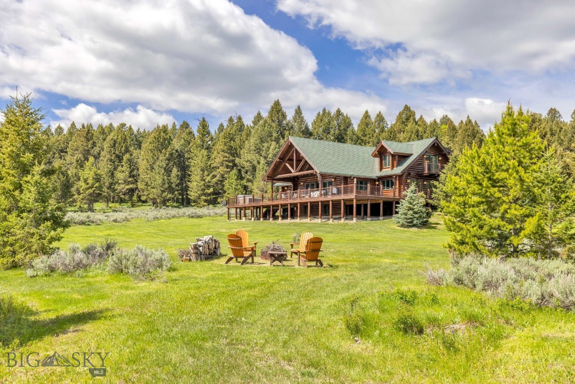 Discover the perfect balance of peaceful Montana living and easy access to Big Sky’s world-class amenities. Set on 20 private acres with sweeping views of the Gallatin Range, this exceptional property offers a true sense of retreat without sacrificing convenience. The main residence features 4 bedrooms, a dedicated office, and a spacious lower level complete with a game room—ideal for entertaining or relaxing. An indoor/outdoor dog kennel, attached two-car garage, and a separate heated three-car garage with a workout room provide modern comforts with rustic elegance. Horse lovers will be drawn to the impressive two-story barn, outfitted with five stalls, a tack room, workshop, and drive-through access. Above, you'll find a beautifully appointed one-bedroom guest apartment with a full kitchen, bathroom, and laundry room—perfect for visitors or extended stays. Enjoy serene moments paddling on the pond, hiking the trails on property, or watching for local wildlife. All of this is just minutes from the slopes, shops, and dining of Big Sky. This is more than a home—it’s a recreational paradise and a rare Montana sanctuary.