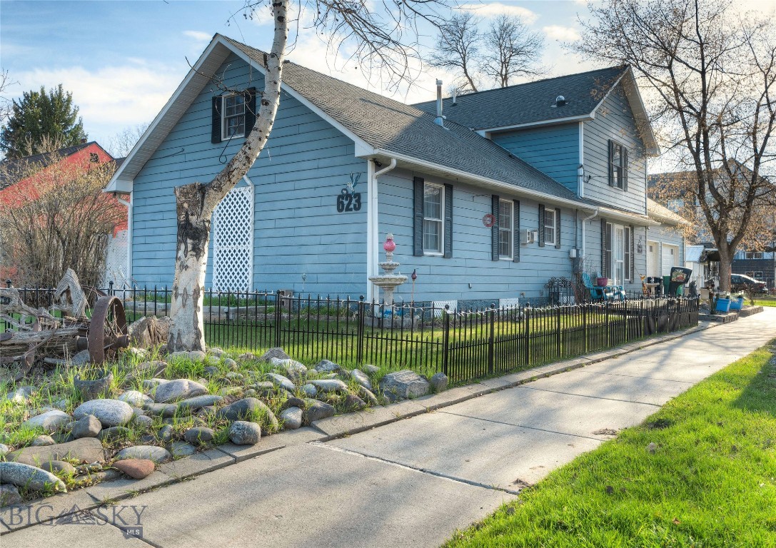 Welcome To 623 N. Grand Avenue! This Expansive 4-Bedroom, 3-Bath Home is Nestled Just Minutes from the Vibrant Heart of Downtown Bozeman.  Offering a Blend of Generous Living Spaces and Endless Opportunities All on An R4-Zoned Lot it’s Time to Make It Your Own! Originally a Quaint Cottage, This Property Received a Significant Enhancing Expansion In 1999.  Step Inside to Discover a Bright, Airy Living Room that Seamlessly Flows into an Updated Kitchen with Stainless Steel Appliances, Ample Counter Space and Plentiful Cabinetry.  A Well-Placed, Full-Lite Door Leads to a Private, Low-Maintenance Paver Patio—Ideal for Your Summer Gatherings and Relaxation. The Main Floor Features a Spacious Primary Suite Boasting a Cozy Sitting Area, Massive Walk-In Closet, En Suite Bath with Double Sinks and a Sizable Tiled Walk-In Shower. You Will Also Appreciate the Convenience of a Large Laundry Room and Full Hall Bath that Complete the Main Level.  Head Upstairs to Find Three Additional Roomy Bedrooms (One Non-Conforming), a Stylish Third Bath with Pedestal Sink and Walk-In Tiled Shower, Plus a Versatile Bonus Room That Could Be Use for Extra Storage or Transformed Into a Fifth Bedroom, Office or Media Space. The Unfinished Basement Presents an Excellent Opportunity for Extra Storage or Potentially Added Living Space.  A Charming Picket-Fence Defines the Front and Side Yard Where You Will Enjoy Stunning Bridger Mountain Views Plus… America’s Pastime Provides Entertainment Nearby on the North Grand Baseball/Softball Fields.An Oversized Insulated 2-Car Garage is Equipped With 240V Service and an Additional Shed.  You will Have the Storage and Project Space You Want and Need. Don't Let This Rare Chance to Embrace the Heart of Bozeman Pass You By—Come and See All the Possibilities This Home Has to Offer!