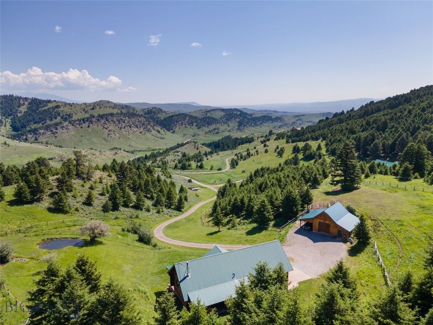 Peaceful and private, the 247± acre Sky Band Retreat is conveniently located between the desirable mountain towns of Bozeman and Livingston, Montana, nestled at the southern base of the Bangtail Mountain Range. Renowned for its abundance of wildlife, trout-filled rivers, and awe-inspiring landscapes, this area stands out as one of the country’s most coveted destinations for recreational properties. Sky Band Retreat does not disappoint, with commanding views of four surrounding mountain ranges, diverse topography, multiple springs, and native vegetation combined to provide an ideal wildlife haven. The 2,138± SF, three-bedroom, two-bathroom custom log home nestled among the pines offers a unique blend of natural beauty, tranquility, energy efficiency, and recreational opportunities, making it an appealing choice for those seeking a picturesque living experience a short distance to amenities.