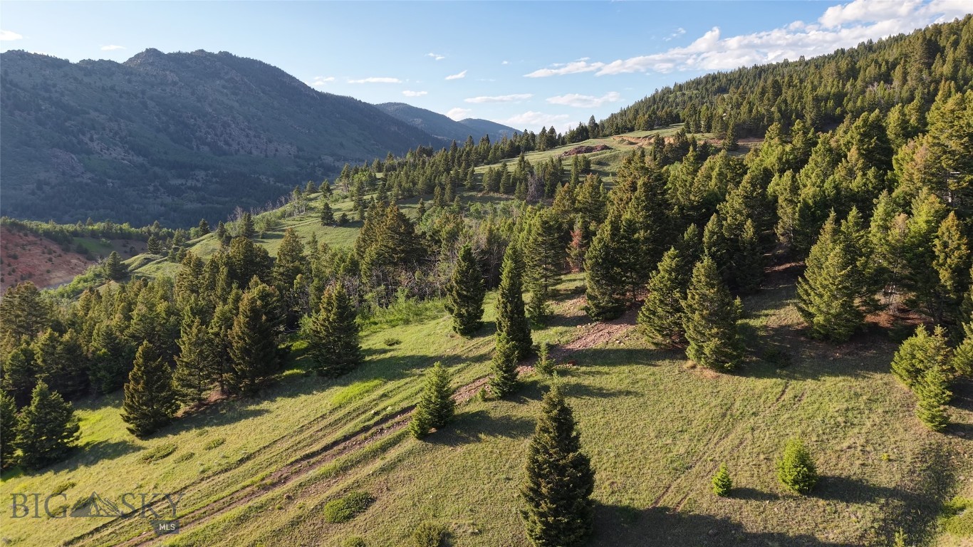 Just outside of Butte, Montana, this 98-acre parcel which is a smaller part of the original Horse Canyon Retreat offering which offers a mix of timber, aspen groves, and open meadows with views of the Highland Mountains and valley. Springs and Douglas Fir provide excellent wildlife habitat, attracting elk and deer throughout the seasons. A solid internal road system allows easy access to multiple building sites, with power available and septic approval already in place. Free of covenants or restrictions, this tract is ready for a wide range of uses, whether as a mountain retreat, recreational basecamp, or private getaway within minutes of town.