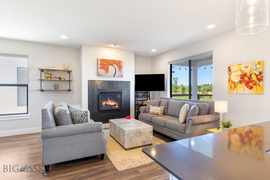 Where the mountains meet the water, this end-unit condo blends Bozeman’s natural beauty with effortless everyday comfort. Located on the park and just steps from the pond, it offers sweeping views from nearly every window and a seamless connection to walking trails just outside your back gate.

Inside, offers a bright open layout that reflects a modern farmhouse charm with a perfect balance of warmth and clean design. The kitchen features a gas range, Butler’s pantry, and thoughtful workspace—ideal for cooking, entertaining, or daily living. The adjoining living area is anchored by a dynamic gas fireplace with a sleek black metal façade, creating a striking focal point that complements the home’s inviting style. Unique, upgraded lighting fixtures—especially the dining area pendant—tie the design together beautifully, blending comfort, character, and understated luxury. From here, step outside to a fenced backyard with underground sprinklers and a wide gate for easy access to the park.

Upstairs, convenience continues with the laundry room and a spacious primary suite featuring a large walk-in closet and well-separated secondary bedrooms for privacy. A heated two-car garage, automatic door, and low-maintenance exterior complete the picture of easy, efficient living.

Located close to Gallatin High School, Town & Country, The Market at Ferguson Farms, a local gym, and easy access to Downtown Bozeman and MSU, this property offers rare balance—city convenience with a country feel, surrounded by open space, sunsets, and the best of Montana living. Seller is a licensed Real Estate Agent.
