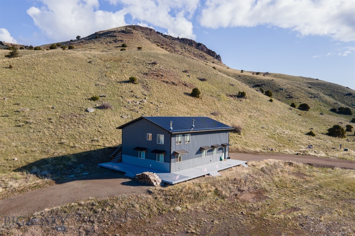 Motivated seller! This is your chance to own your Montana dream retreat on 19 acres in scenic Paradise Valley. Opportunity to live in the current home while building your dream property right next door. This property offers unmatched views of Emigrant Peak, Electric Peak, Dome Mountain, and the breathtaking expanse of Paradise Valley. Current residence is a 2022 build, featuring 2 bedrooms, 2 full bathrooms, great kitchen and open living space with views out every window. A 1,000 square foot attached garage shop space with Hearthstone Castleton high-efficiency wood stove, two 14’ insulated garage doors, 192 square foot loft with storage and workspace with 30-amp and 50-amp service, and 50-amp RV hookup outside. Take in all the views on the 1,000 square foot trex wraparound south facing deck, while still enjoying great privacy. This property is ready for a new owner to be able to build a new home next to the current home on the property. With extensive excavation already completed, separate electrical service installed for the future home, a high-producing well (12 GPM, 660’ depth, 68°F average temperature – ideal for geothermal heating and cooling), a new owner can use the premier building site with completed architectural plans for a custom 3,000+ square foot home or come up with a new concept. Unbeatable location being 2 minutes from the Yellowstone River, 10 minutes from Chico Hot Springs, 20 minutes to Yellowstone Hot Springs, 30 minutes to the North Entrance of Yellowstone National Park, ~30 minutes to Livingston MT, and ~55 minutes from Bozeman MT. Properties like this one don't come along often, don't wait to call this one home!
