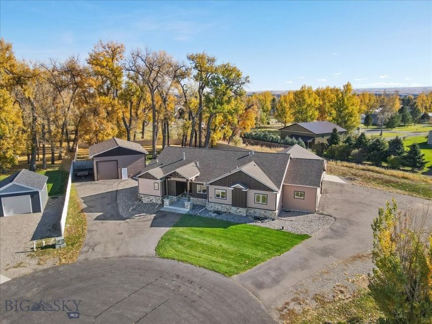 This 4,504 sq. ft. refined rustic residence is a home that welcomes you in and invites you to stay, offering elevated comfort, thoughtful design, and exceptional space for everyday living and entertaining. Set on just over an acre of fully fenced land and backing to 10 acres of Yellowstone County open space, this property delivers privacy, beauty, and stunning fall and winter views.

The main level features three bedrooms and 2.5 baths, including a spacious primary suite with a large spa-like bath, walk-in shower, and his-and-her closets. Artwork in the primary bedroom is by local artist Ruby Hahn. The kitchen is both functional and striking with hickory cabinetry, stainless steel appliances, a gas range, and generous space designed for gathering. Custom design walls throughout the home reflect craftsmanship and attention to detail, while a central vacuum system adds everyday convenience.

The lower level is designed for entertainment and relaxation, offering two additional bedrooms and a full bath, a weight room, hobby room, along with an impressive theater room and bar area. A large screen and sound system create the ultimate movie-night experience, with ample room for hosting family and friends. 
Adding exceptional versatility is a shop with approximately 1,800 sq ft (+/-) of livable space, featuring two bedrooms, a full bathroom, full kitchen, washer and dryer, and radiant heat and air conditioning—ideal for guests, family, or potential income opportunities.

Blending refined rustic style with relaxed elegance, this property offers luxury that feels livable in a setting that is both private and connected to nature. A true retreat designed for comfort, gathering, and lasting memories.