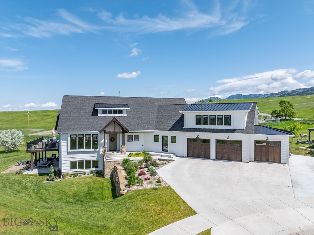 Welcome to 1055 Caddie Court—where thoughtful design meets mountain luxury in the sought-after Bridger Creek subdivision. Located on a spacious 0.78-acre lot on a quiet cul-de-sac and backing to open space, this 4,408 SF, 6-bedroom home offers the perfect blend of privacy, views, and proximity to all things Bozeman. Built in 2021, the home is just minutes from Downtown, Bridger Creek Golf Course, and a network of hiking and biking trails. Step inside to a beautifully crafted interior featuring vaulted ceilings, a gas fireplace, and a sunlit open-concept great room that opens to a large wrap-around deck—perfect for entertaining or enjoying panoramic views of the Spanish Peaks and Tobacco Root Mountains. The main-level primary suite offers a peaceful retreat with a soaking tub, tiled walk-in shower, and a generous walk-in closet. The office/playroom adjacent to the Great Room provides flexible space to fit your lifestyle. The beautifully appointed kitchen features a large center island, GE Café appliances, and a striking blend of hickory and alder cabinetry. And don’t miss the walk-in pantry with built-in shelving and additional fridge/freezer. A roomy laundry room with sink and counter space, a convenient mudroom drop zone, and an oversized heated 3-car garage round out the main floor’s functionality.
Upstairs, you'll find two well-sized bedrooms and a full bath, while the fully finished walkout lower level includes three more bedrooms—one of which is a second suite with ¾ bath—plus a spacious family room with wet bar that opens to a covered patio with built-in fire pit area. Perfect for hosting or multi-generational living.
Additional high-end upgrades include a whole-home integrated sound system, reclaimed wood accent walls, custom live-edge vanity in the powder room, whole-home humidification, RO water system, dual hot water heaters, and abundant storage space. With its premium location, thoughtful layout, and upscale finishes, this home offers the best of Bozeman living—whether you’re gathering with friends, working remotely, or exploring the trails just outside your door.