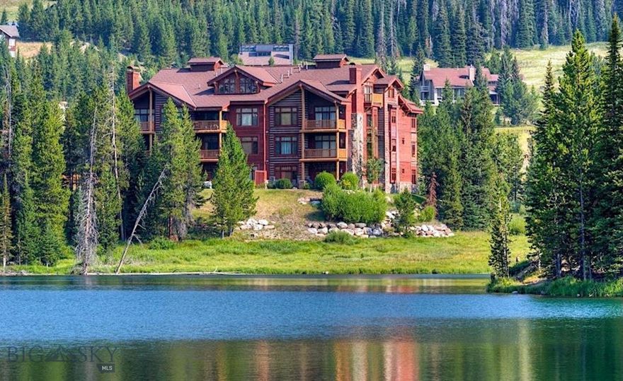 Offering an unparalleled living experience at the base of Big Sky Resort, this 3-bedroom, 3-bath condominium encompasses 2,007 square feet of elegant mountain living. Every detail reflects thoughtful craftsmanship and timeless design, with radiant heated hardwood floors, knotty Alder doors and trim, Viking appliances, granite countertops, and a spa-like master suite with a jetted soaking tub—perfect after a day on the slopes. 

Designed for both comfort and entertaining, the open concept living room, anchored by a cozy fireplace and expansive windows, invites you to gather with friends while taking in breathtaking views of Lone Peak and Lake Levinsky. A covered balcony extends the living space outdoors, providing a front-row seat to Big Sky’s alpine beauty. Each private suite offers its own bath ensuring privacy and comfort. Convenience is unmatched with a private underground single car parking garage, additional outdoor parking, and direct access to the Skyline shuttle stop—ensuring effortless connection to skiing, dining, and resort amenities. 

Beyond your door lies the heart of Big Sky Resort.  Providing a picturesque backdrop of natural beauty that enchants residents and visitors alike.  In winter, enjoy direct access to world-class skiing and snowboarding. In the warmer months, explore hiking in Beehive Basin, biking the Mountain to Meadow trail, kayaking on Lake Levinsky, fly fishing Montana’s legendary Blue Ribbon waters, or venturing into the wild beauty of Yellowstone National Park. This property not only provides a luxurious retreat but also a front-row seat to Big Sky’s year-round adventures. 

Tastefully furnished, every corner exudes warmth and sophistication, The residence is being offered fully furnished and turnkey, with existing rentals already on the books—a rare opportunity for both personal enjoyment and immediate revenue potential. Please inquire for detailed cost of ownership and revenue forecasting. Whether you’re seeking a private getaway, a luxurious base camp for outdoor pursuits, or a high-end short-term rental, this condo is more than a home—it’s your personal retreat in Montana’s most sought-after resort community.