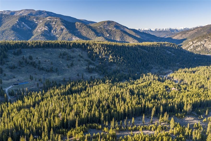 The land opens wide and rolls easy, framed by mountains on the horizon and the slow, particular light Montana is known for. Privacy here is rare, the views are wide, and the conveniences of Big Sky remain a short drive away.
What sets this homesite apart is readiness. The well is drilled and the septic is installed, offering an unusually approachable path to beginning your life in Montana on a timeline shaped by you rather than by permitting and infrastructure schedules.

For all its seclusion, the location is uncommonly connected. Big Sky Town Center is under ten minutes away, placing daily errands, restaurants, and gathering places easily within reach. The Gallatin River, home to some of the most storied fly water in the West, sits five minutes from the property. Big Sky Resort is twenty minutes up the mountain, with world-class skiing, hiking, and a full mountain calendar at the ready. Bozeman Yellowstone International Airport is roughly an hour out, and Yellowstone National Park forty-five minutes from your future door. Few parcels in the region sit so naturally between mountain, river, town, and beyond.

The acreage allows for thoughtful planning: a primary residence positioned for the views, generous setbacks, room for a barn or guest quarters, and the kind of buffer that protects what drew you here in the first place. The terrain works with the structure rather than against it, and the surrounding topography reinforces the sense of arrival rather than interrupting it.

Michener Meadows itself carries a particular character within the Big Sky landscape. It is open country, settled but not crowded, with a rhythm shaped by the seasons and the wildlife that move through it. Owners here value land for what it is rather than what can be built on top of it, and the result is a neighborhood defined by space and natural beauty.

Few homesites in the area combine ready infrastructure, twenty acres of remarkable land, and a setting this composed. The systems are in. The setting is established. The acreage offers a latitude that has become increasingly difficult to find this close to town.