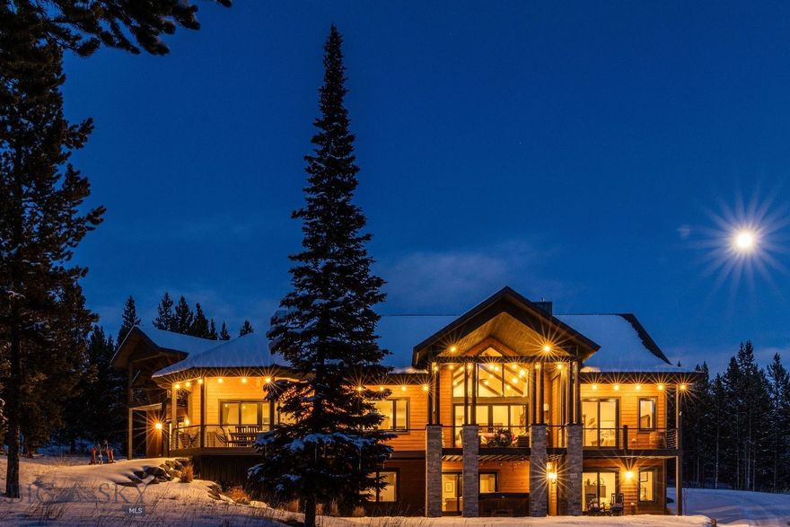 Ski-in, ski-out access, Lone Peak views, and quiet cul-de-sac living come together at this elegant home in the Cascade neighborhood. The vaulted great room brings in natural light and frames the surrounding landscape, while two main-level gathering areas—each anchored by a fireplace—offer comfortable places to unwind after time on the mountain. The chef’s kitchen features custom cabinetry, an oversized gas range and hood, panel-front refrigeration, solid surface counters, and an island sized to host, as well as every day use. Outdoor living extends across spacious covered decks and a lower patio with a hot tub, all set among 1.519 wooded acres.

The main-floor primary suite sits privately on its own wing, while the bonus suite above the garage provides a generous, quiet space for guests. The lower level adds a rec room, wet bar, bunk room, and two additional bedrooms,  with easy walkout access to the patio and ski trail. A dedicated ski room with lockers and a gear dryer keeps equipment organized and ready for the next run.

Moments from Big Sky Resort and the emerging One&Only, this home pairs true mountain access with a layout designed for comfortable year-round living.