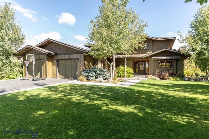 Outstanding opportunity to own this craftsman-styled, custom-built by Anders Lewendhal home overlooking Nash Spring Creek and Tuckerman Park. Nestled at the edge of serene nature trails, this custom home offers the perfect blend of tranquility and convenience. Imagine stepping out your front door and being greeted by winding trails that invite you on morning hikes or peaceful evening strolls. Natural colors, with popping red accents create an inviting entry to this wonderful home. Your main entry is nothing short of spectacular, with its hearty, custom-patterned slate floors, reclaimed timber, and vaulted ceiling draped by natural light and capped by a repurposed historic stained-glass window. Interior spaces emphasize gathering with oversized entry, living room, and dining room perfect for entertaining and family gathering.  Spacious kitchen offers custom cabinetry and is anchored by an 8 burner Viking dual fuel range and custom hood installed in 2025.  The everyday dining area spills out onto a wonderful eastside patio and secluded backyard overlooking Nash Spring Creek, perfect for summertime barbeques in a private setting. It is thoughtfully arranged with the primary bedroom on the main floor and three bedrooms and a family room on the second floor. There is a total of five bedrooms, two full baths, one ¾ bath, and one-half bath, this lovingly appointed home can easily accommodate your family, with room for visiting guests as well. A variety of natural stone adorns this spectacular home - from teakwood marble to Portuguese Gascogne Blue limestone and deep-hued purple Brazilian slate and Italian Mirage granite- all of which must be seen to be fully appreciated. The exterior features craftsman-styled finishes of cedar shake, and board-and-batten finish surrounded by mature landscaping and flower beds. Located on the southern edge of Bozeman city limits, with beautiful unobstructed south-facing views over the silos of Goldenstein’s farm, enjoy country-styled openness in remarkably close proximity to schools, within minutes, you can reach the vibrant downtown area, making it easy to enjoy local dining, shopping, and entertainment.