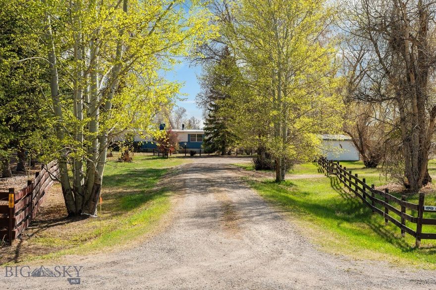 There’s something special about a place that has been lived in and loved, and this 1.4-acre property offers the kind of peaceful setting that’s getting harder to find close to town. Tucked behind a tree-lined driveway with mature landscaping and room to spread out, it’s a property that has been cared for and enjoyed by the same family for many years, raising their own family and welcoming grandchildren through the same front gate. 

The property  is being sold as land with a manufactured home- it is not de titled and is taxed as personal property.  It has been maintained over the years and offers a comfortable layout with plenty of potential for the next owner. Inside you’ll find a cozy wood stove, breakfast area, kitchen with a new dishwasher, dining room with built-ins, and a welcoming living room. Down the hall are two guest bedrooms, a full guest bath, and a spacious primary bedroom with a walk-in closet and private bath.

The enclosed back porch opens to the backyard where there is a shop that has served as a workspace for many projects over the years, along with a storage shed. There is also a two-car garage in the front of the home. An antique iron fence and matching gate add character to the front yard, while a brick walkway leads to the new front deck and entry.

The property also features a newly installed well, adding long-term value and peace of mind.
Whether you’re looking for a comfortable place to call home, a property with room to personalize, or simply acreage with a quiet setting near town, this property offers a great opportunity to make it your own.