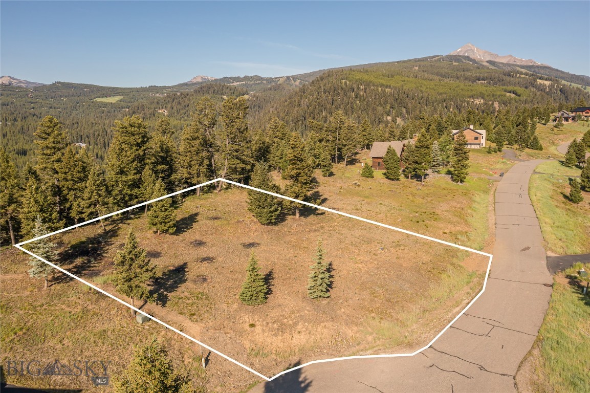 Discover the Best of Big Sky Living at Antler Ridge
Welcome to Antler Ridge — a highly sought-after neighborhood perfectly positioned to capture everything that makes Big Sky so special. 765 Antler Ridge lot is one of the last "ridge view" lots that have not already been built on and is located about halfway between the vibrant Mountain Village and the Town Center making this an ideal place to build your dream home in the heart of Montana’s premier alpine community.
Located on the top row of the ridge at the end of the Antler Ridge cul de sac, this 0.41-acre lot offers sweeping, unobstructed views. Gaze north to the majestic Yellow Mountain and the dramatic Spanish Peaks, and enjoy peaceful southern forest and mountain vistas right out your back door.
What truly sets this property apart is its unique location bordering over 190 acres of Antler Ridge's pristine open space, giving you a sense of privacy that feels far larger than the lot’s footprint. Whether you envision cozy nights under star-filled skies, adventures on the hiking, biking and cross country ski trail that connects to the Lone Mountain Ranch trail system or simply soaking up the breathtaking scenery from your future deck, this setting offers the perfect canvas for your Montana lifestyle.