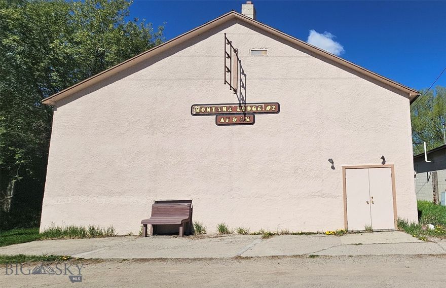 INVESTMENT OPPORTUNITY!! Located just one block from Downtown Ennis!!   This 6880+/- square foot Historic Building offers a tremendous amount of square footage and potential  for a multitude of possibilities.  The stunning hardwood floors serve as the focal point when entering the great room and offers a great space for various activities and events.  With the spacious layout, the possibilities are endless, whether it's used for gatherings, performances, workshops, or even as a studio space. Also on the main level are two bathrooms a dressing room and storage room. The lower level reveals another expansive area, featuring a large open room complemented by a spacious kitchen, ideal for hosting larger gatherings or catering events. Two additional bathrooms on this level add further convenience and functionality. It's location near downtown Ennis adds to its appeal, short walk to all amenities including the Madison River and Lyons Park! Own a piece of Montana history!