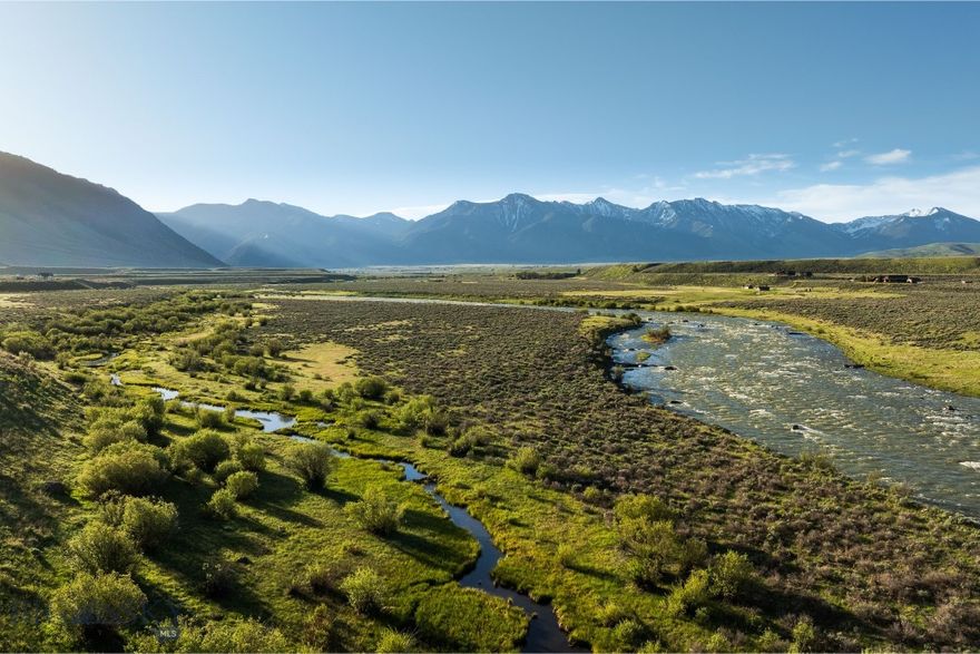 Set along one of the Madison River’s most scenic corridors, Madison Spring Creek Ranch spans 228± acres with 0.5± miles of private river frontage and a significant spring creek. The terrain is strikingly varied, rising over 100 feet from the river and willow-lined creek bottom to elevated benches with panoramic views of the surrounding ranges, including the 10,000-foot peaks of the Gallatin and Targhee National Forests. The upper elevations offer scale and unobstructed vistas, while the lower reaches form a rare, protected riparian oasis in a landscape more often defined by wide-open grasslands. A documented elk migration corridor, the property supports a wide range of wildlife throughout the seasons. While much of the surrounding viewshed is protected by conservation easements or public lands, Madison Spring Creek Ranch remains unencumbered—offering flexibility for the next owner and clear potential as a conservation candidate given its ecological significance.

The Madison River is regarded as one of the world’s premier fly-fishing destinations, and the wade-only section near Three Dollar Bridge is arguably its most coveted stretch. Positioned in the heart of this legendary water, Madison Spring Creek Ranch offers a rare chance to own significant river frontage in a valley where properties are often generationally held.