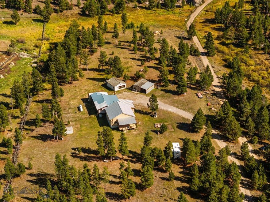 Welcome to a home where country living and outdoor adventure come together. This 4-bedroom, 2-bath sits on just over 10 acres with no HOA, giving you the freedom to live the Montana lifestyle your way. A brand-new addition makes it easy to gather friends and family—whether for holidays, celebrations, or quiet evenings by the fire.

The property is set up for goats, chickens, turkeys, and more, with fencing that secures your animals while still allowing wildlife to pass through. A seasonal creek adds to the setting, creating a peaceful backdrop right outside your door.

Adventure begins the moment you step outside. The Continental Divide Trail, Thompson Park, and Beaverhead - Deerlodge National Forest are all close by, offering endless opportunities for hunting, hiking, biking, horseback riding, and wildlife viewing. And when you need to connect with the wider world, Butte and Bert Mooney Airport is about a 15 minute drive away.

Here, mornings start with feeding animals, afternoons with a trail ride or mountain hike, and evenings watching the elk, deer and more with family gathered close. This isn’t just a home—it’s pure Montana living.