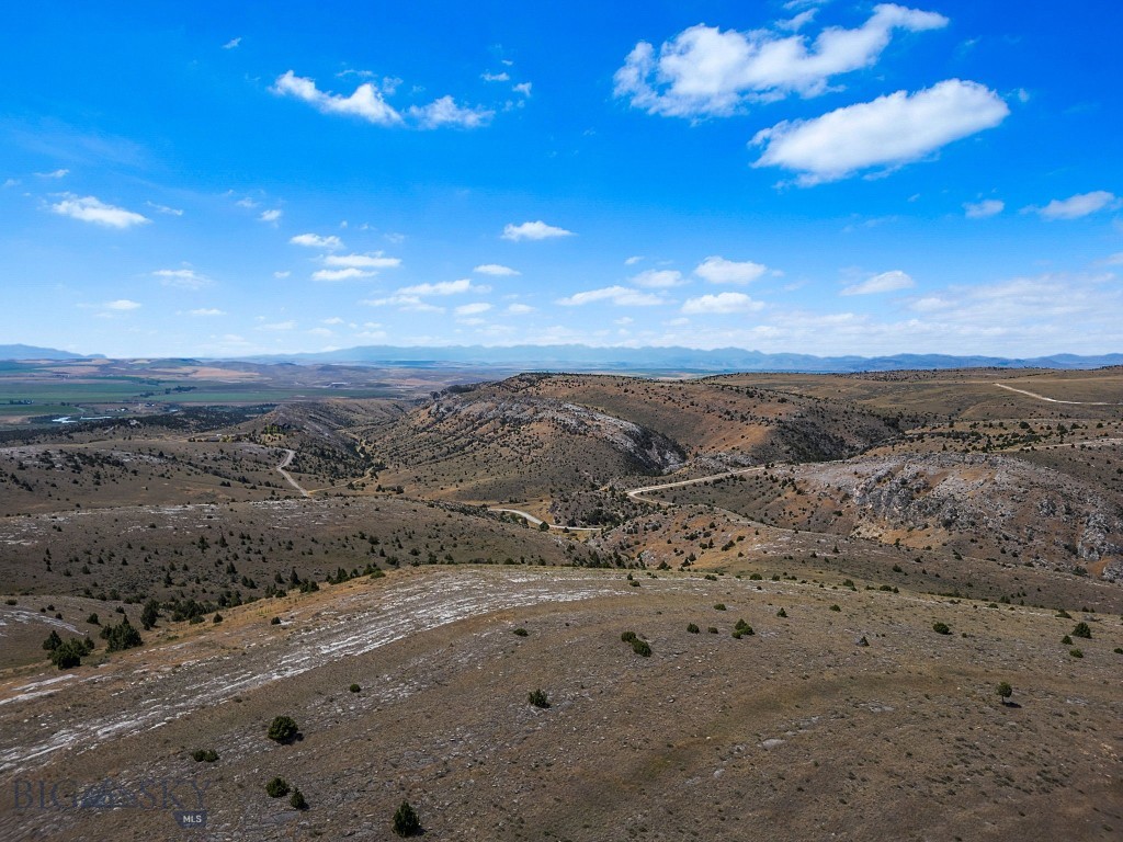 Welcome to 19.85 acres of pristine Montana beauty in the sought-after Gallatin River Ranch community, just minutes outside of Manhattan. This expansive parcel offers the perfect blend of privacy, open space, and access to nature. Bordering a public state section along its northern boundary, this lot offers an extended sense of seclusion and recreational opportunity right out your back door. Gaze out across stunning southwest views that stretch for miles—an ideal backdrop for your dream home, retreat, or investment. The gently rolling terrain makes for a flexible build site, with ample room for horses, outbuildings, or simply room to breathe. Gallatin River Ranch is a private, 5,900-acre community known for its sweeping views, wildlife, and access to the legendary Gallatin River. Residents enjoy exclusive access to a private stretch of the river for fishing and floating, as well as maintained roads, hiking and riding trails, and a nearby equestrian center. With a highly competitive price point and unmatched surroundings, this is a rare opportunity to own a large slice of unspoiled Montana. Don’t miss your chance to be part of this truly special community.